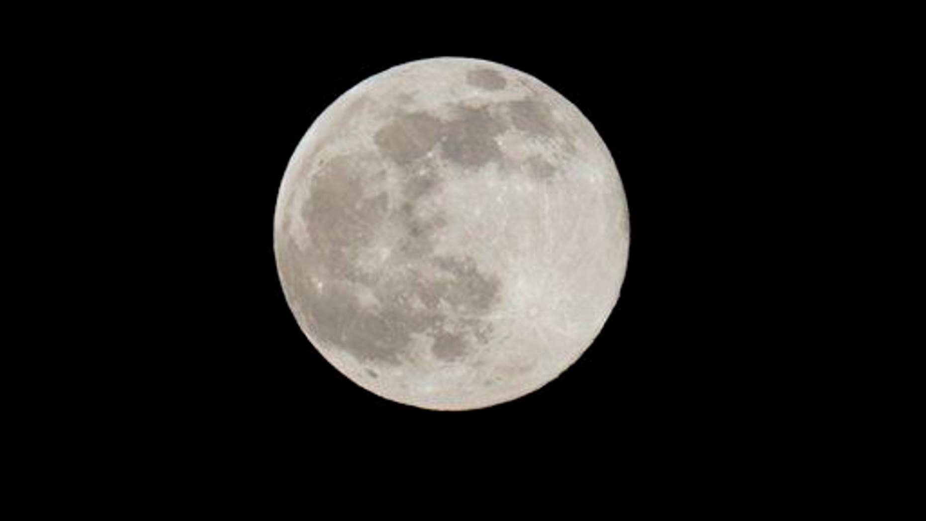 A Blue Moon rises Friday, July 31, 2015 as seen from Taguig city east of Manila, Philippines.