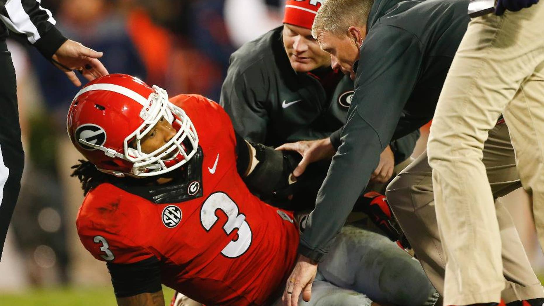 Members of the Georgia medical staff tend to injured running back Todd Gurley in the second half of an NCAA college football game against Auburn Saturday, Nov. 15, 2014, in Athens, Ga. Georgia won 34-7. (AP Photo/John Bazemore)