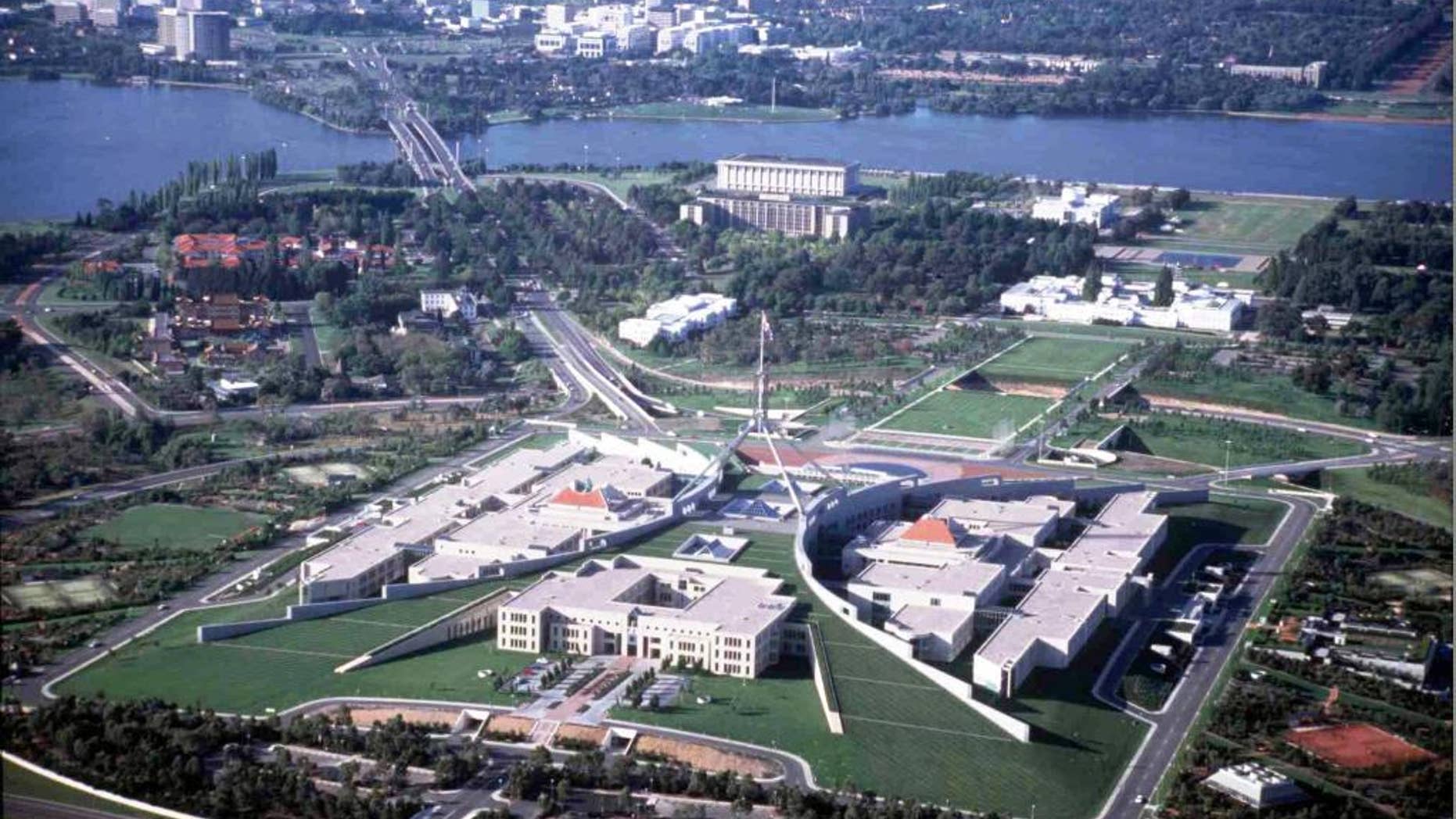 FILE - This undated aerial photo shows Parliament House in Canberra, Australia, and the downtown area at the top. Australia's Parliament House on Monday, Oct. 20, 2014 lifted a short-lived ban on facial coverings including burqas and niqabs after the prime minister intervened. (AP Photo/Canberra Tourism)