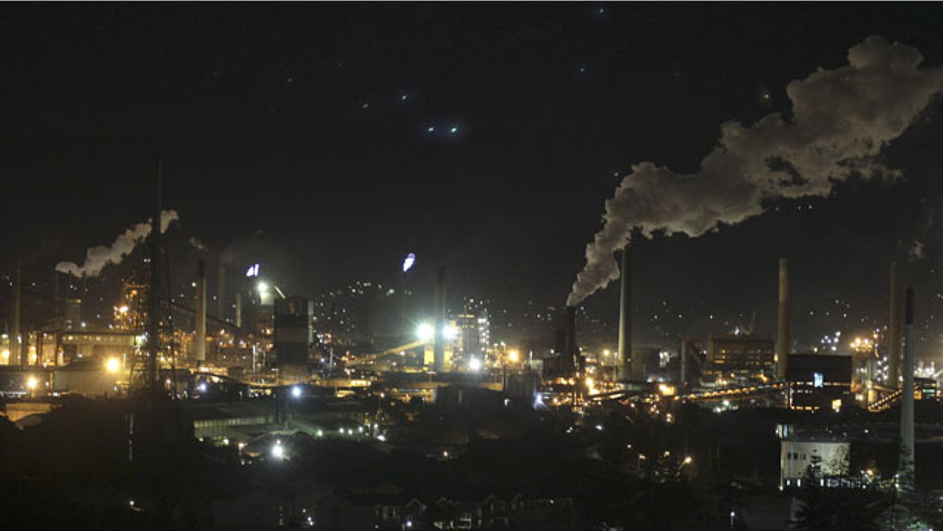 In this Friday, July 8, 2011 file photo, smoke bellows out of a chimney stack at Bluescope Steel works at Port Kembla, south of Sydney, Australia. (AP Photo/Rob Griffith, File)
