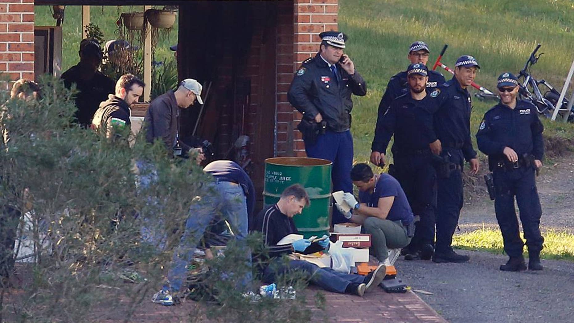 Police search the property and family home of Leonard John Warwick in Douglas Park, near Sydney, Australia, Wednesday, July 29, 2015. More than 30 years after series of bombings and shootings left four people dead and terrorized the Australian legal fraternity police have arrested Warwick, a 68-year-old suspect. (David Moir/AAP Image via AP) NO ARCHIVING, AUSTRALIA OUT, NEW ZEALAND OUT, PAPUA NEW GUINEA OUT, SOUTH PACIFIC OUT, NO SALES