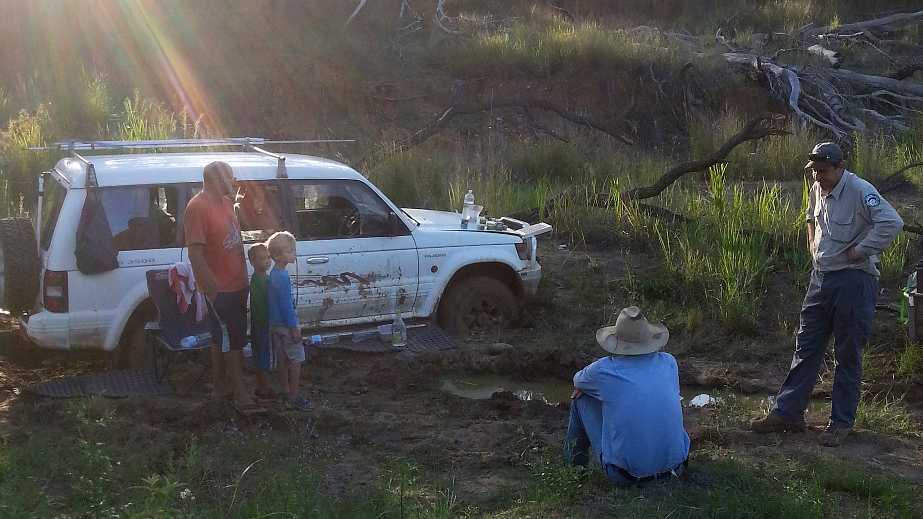 Dec 22, 2014 - Steven Van Lonkhuyzen, left, with his sons Timothy, 5, second left, and Ethan, 7, third left, speaks to farmer Tom Wagner, center, and a park ranger after being rescued in the remote Expedition National Park, northwest of Brisbane in Australia. On Dec. 11, Van Lonkhuyzen took a wrong turn and got his car stuck in mud.
