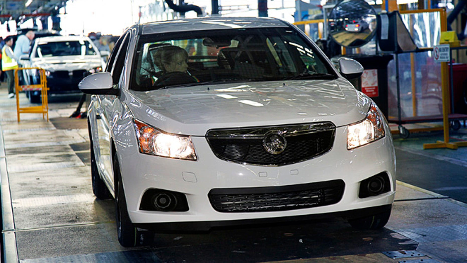 FILE - In this undated file photo released by General Motors Co., a Holden Cruze hatch is driven off the assembly line after it was manufactured at a plant in Australia. General Motors Co. said Wednesday, Dec. 11, 2013, it will stop making cars and engines in Australia by the end of 2017, with nearly 2,900 jobs to be lost, because of high production costs and competition. GM's Australian subsidiary Holden once dominated Australian auto sales, but lost market share to imported cars. (AP Photo/General Motors, File)