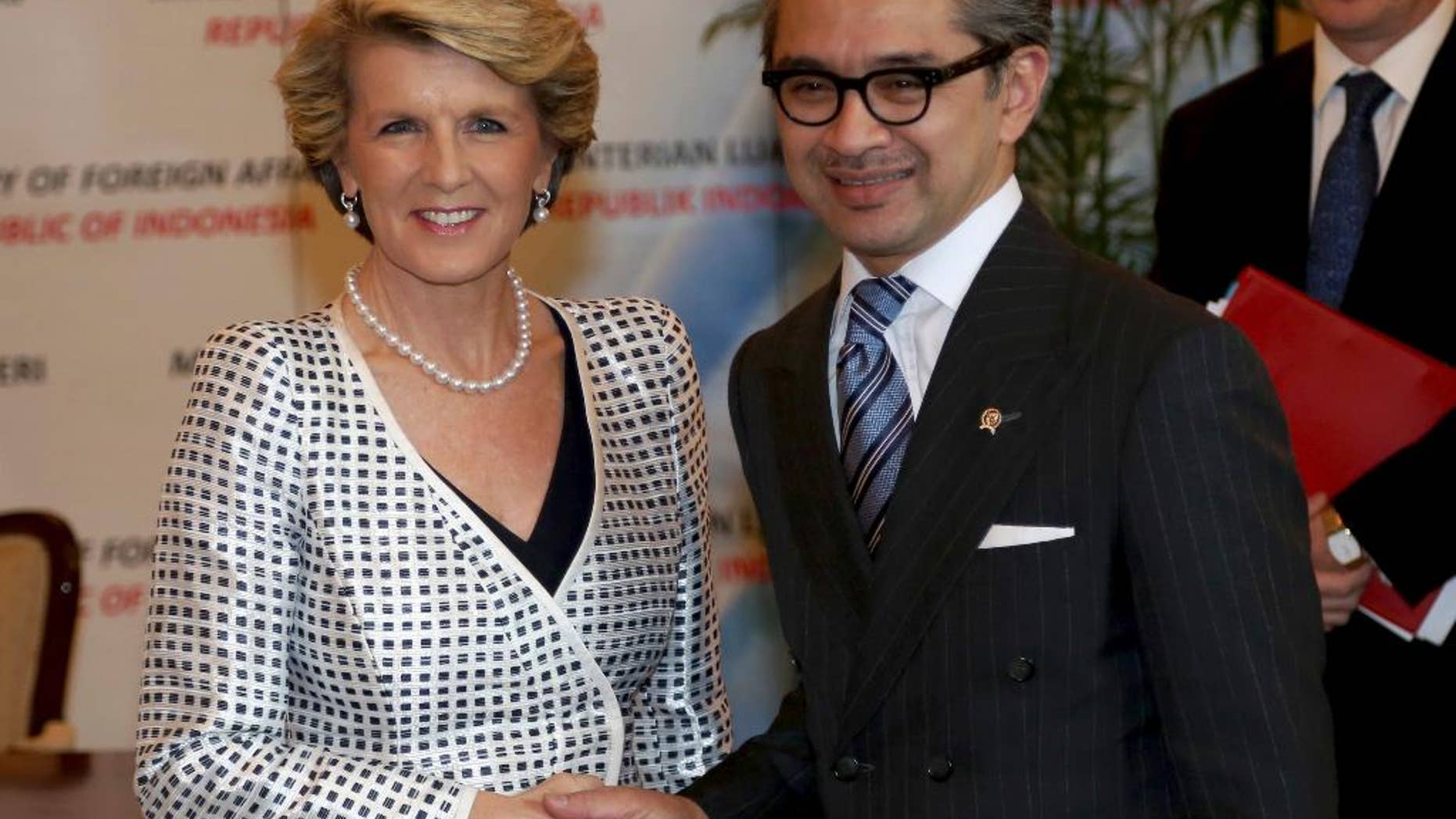 FILE - In this Dec. 5, 2013 file photo, Australian Foreign Minister Julie Bishop, left, is greeted by his Indonesian counterpart Marty Natalegawa prior to their meeting in Jakarta, Indonesia. Australia and Indonesia have reached a new agreement on how they'll use their intelligence operations in the future, even settling their disagreement on its name. The agreement Bishop and Natalegawa are scheduled to sign Thursday, Aug. 28, 2014 on the Indonesian resort island of Bali is designed to mend a rift sparked last November by accusations that Australians tapped the cellphones of the Indonesian president, his wife and eight ministers and officials in 2009. The document with the ungainly title of "Australia-Indonesia Joint Understanding on a Code of Conduct" was insisted upon by the Indonesians before diplomatic relations are normalized. (AP Photo/Tatan Syuflana, File)