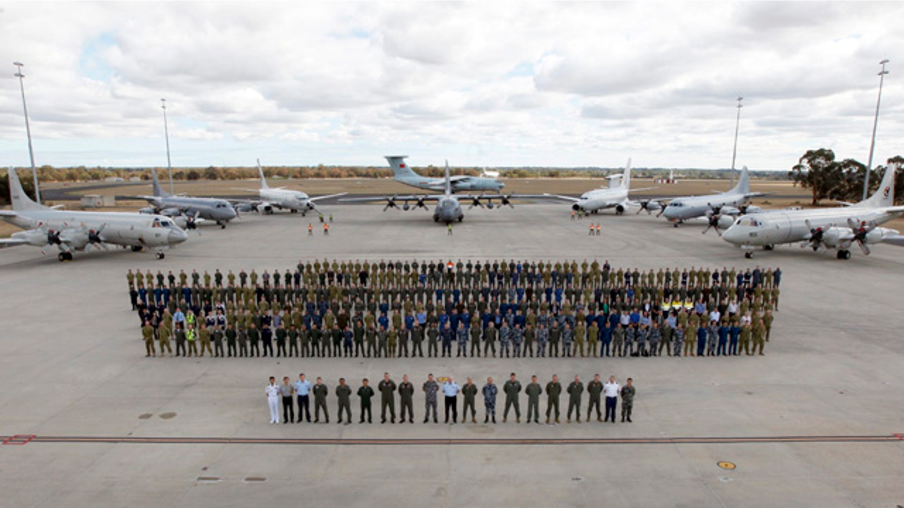 April 29, 2014: In this photo provided by the Australia Defence Force, multinational air-crew and aircraft involved in operation 'Southern Indian Ocean' are assembled for a photo at RAAF Base Pearce, in Perth, Western Australia. Seven nations, including Australia, New Zealand, the U.S., South Korea, Malaysia, China and Japan, have flew daily search mission out to the southern Indian Ocean in the massive multinational hunt for the missing Malaysia Airlines Flight 370. (AP Photo/Australian Defence Force, Cpl. Nicci Freeman)