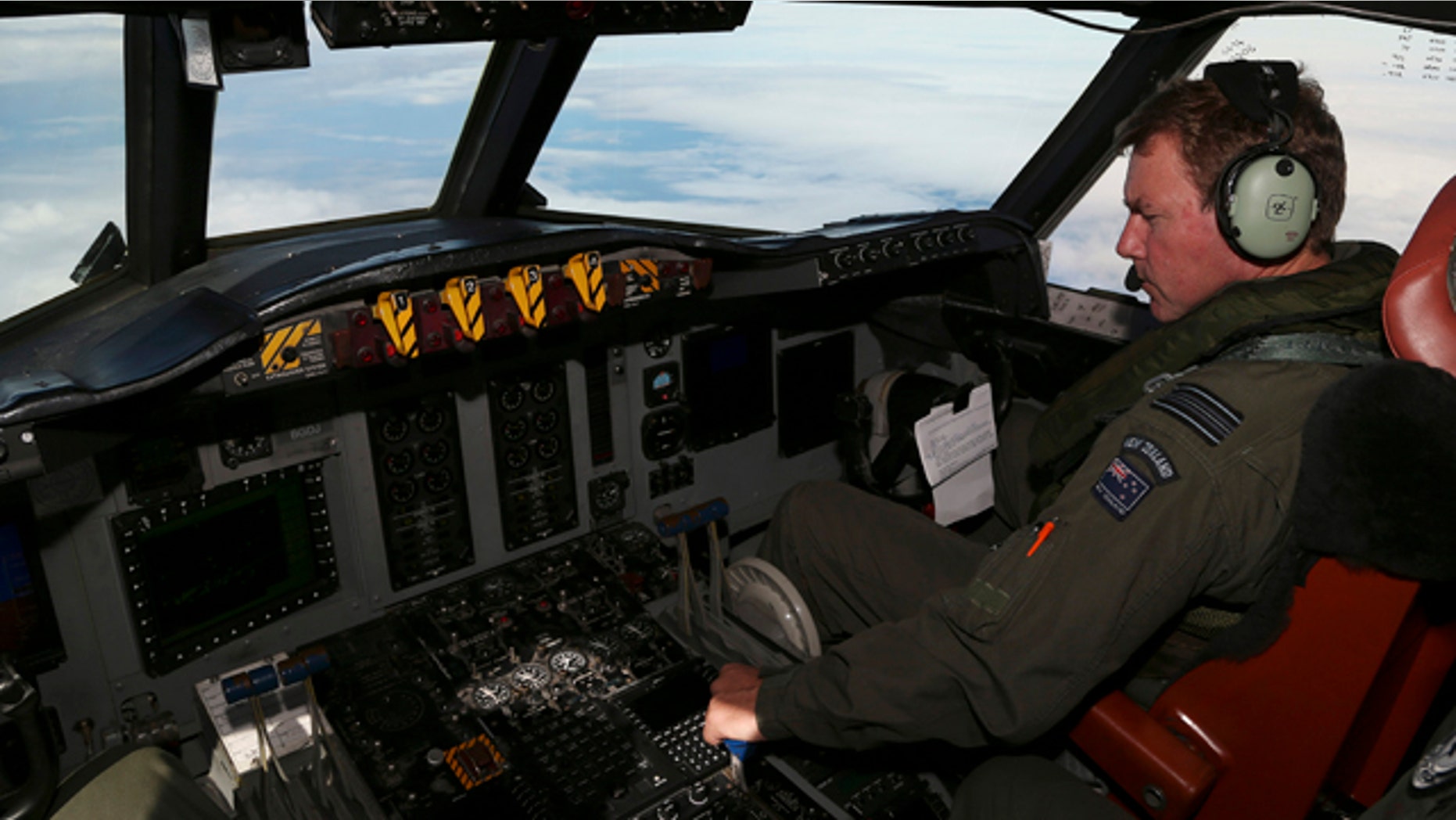 March 31, 2014: A Royal New Zealand Air Force P-3 Orion's co-pilot and Squadron Leader Brett McKenzie controls the pane while searching for the missing Malaysia Airlines Flight MH370 in the southern Indian Ocean. (AP Photo/Rob Griffith)