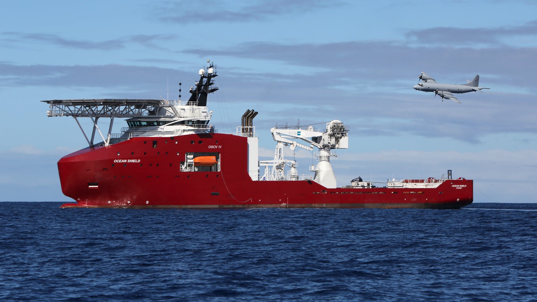 In this April 9, 2014 photo provided by the Australian Defense Force, a Royal Australian Air Force AP-3C Orion flies past Australian Defense vessel Ocean Shield on a mission to drop sonar buoys to assist in the acoustic search of the missing Malaysia Airlines Flight 370 in the southern Indian Ocean. The ship searching for the missing Malaysian jet has detected two more underwater signals that may be emanating from the aircraft's black boxes, and the Australian official in charge of the search expressed hope Wednesday that the plane's wreckage will soon be found. (AP Photo/Australian Defense Force, LSIS Bradley Darvill) EDITORIAL USE ONLY
