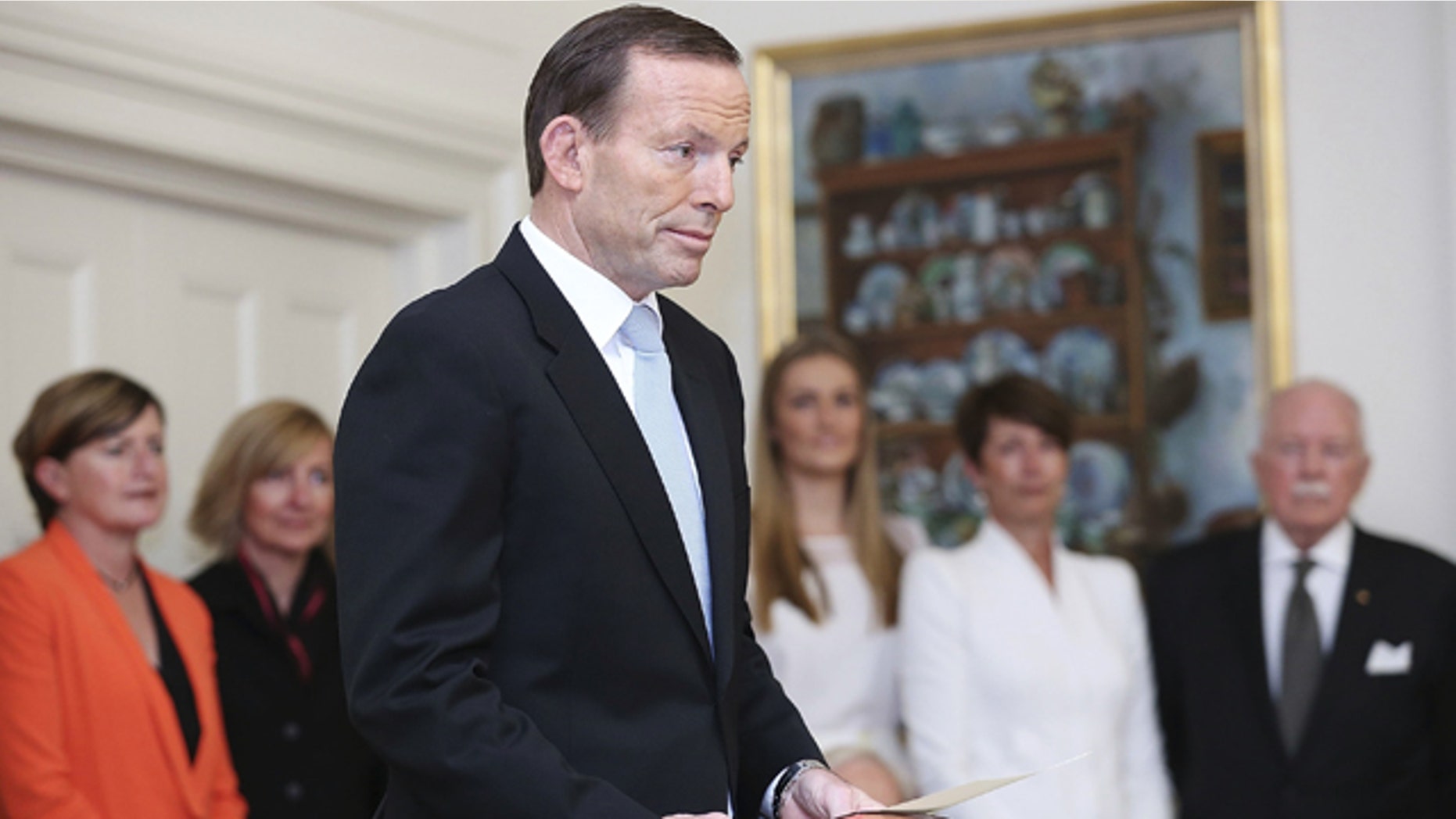 FILE - In this Sept. 18, 2013 file photo, Tony Abbott is sworn in as the 28th prime minister of Australia at Government House in Canberra, Australia. (AP Photo/Stefan Postles, Pool, File)