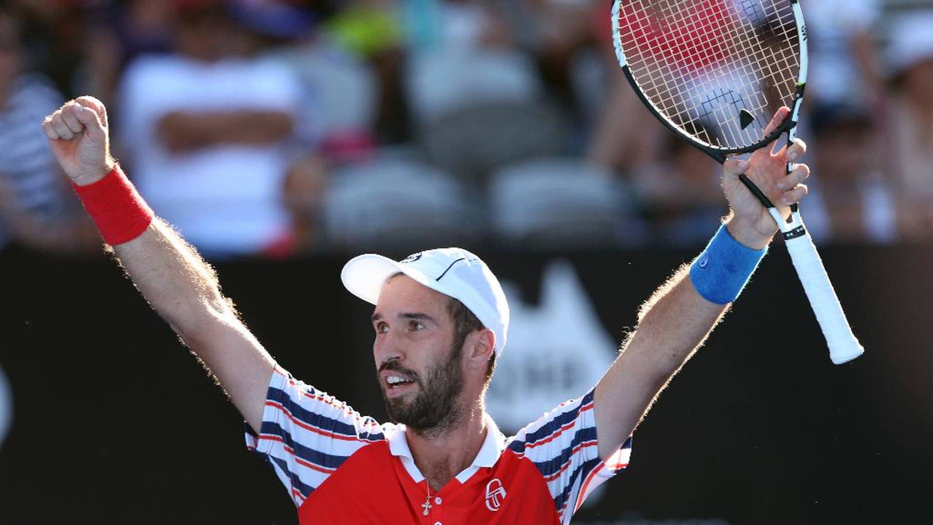 Mikhail Kukushkin of Kazakhstan raises his arms as he celebrates winning his match against Juan Martin del Potro of Argentina at the Sydney International Tennis tournament in Sydney, Australia, Thursday, Jan. 15, 2015. (AP Photo/Rob Griffith)