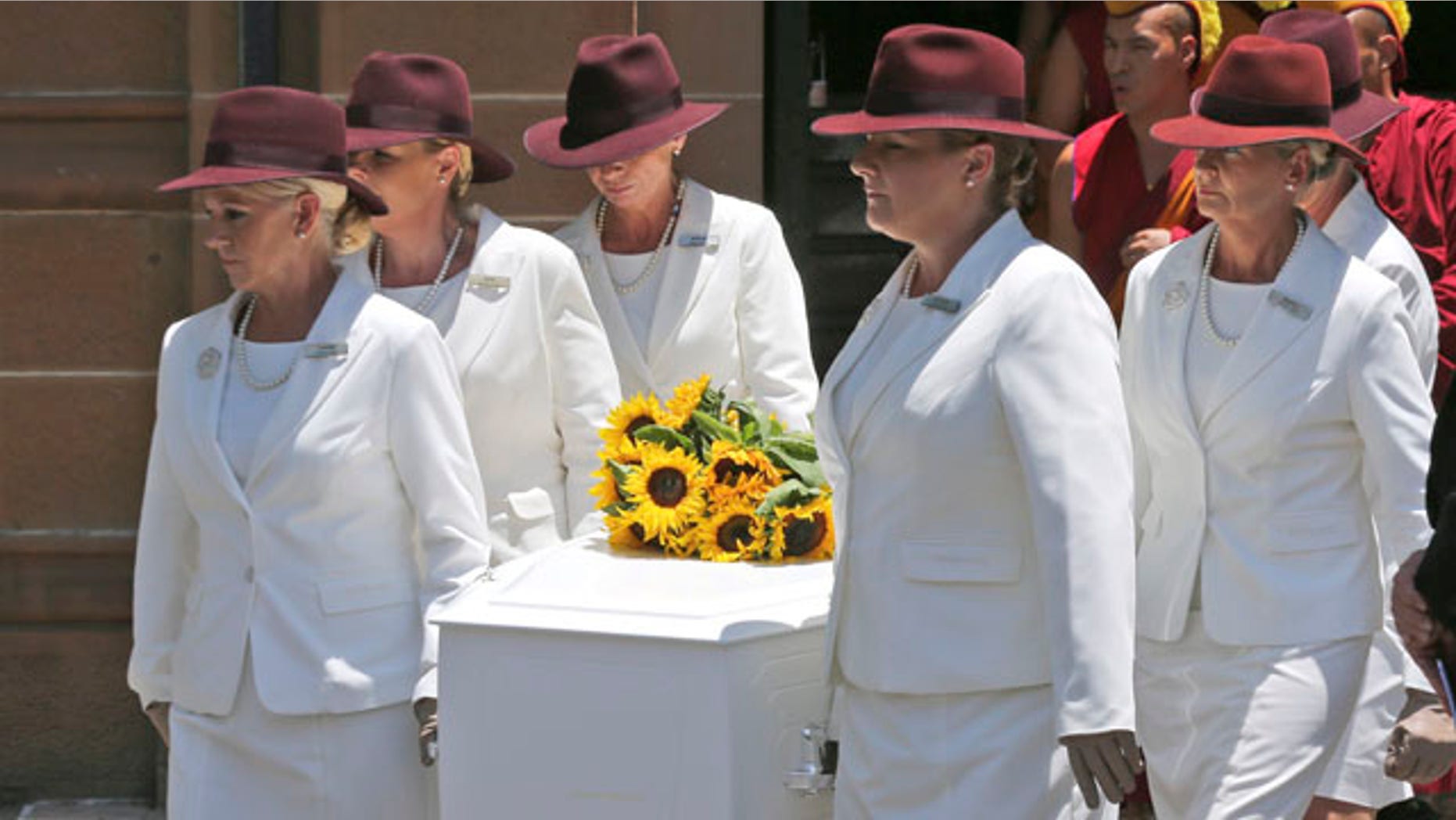 Dec. 23, 2014: White Lady funeral directors carry the coffin of Tori Johnson during a funeral service in Sydney, Australia. Johnson was one of three people, including the gunman, who were killed during a siege in the Lindt cafe coffee shop in Sydney last week.(AP Photo/Rob Griffith)