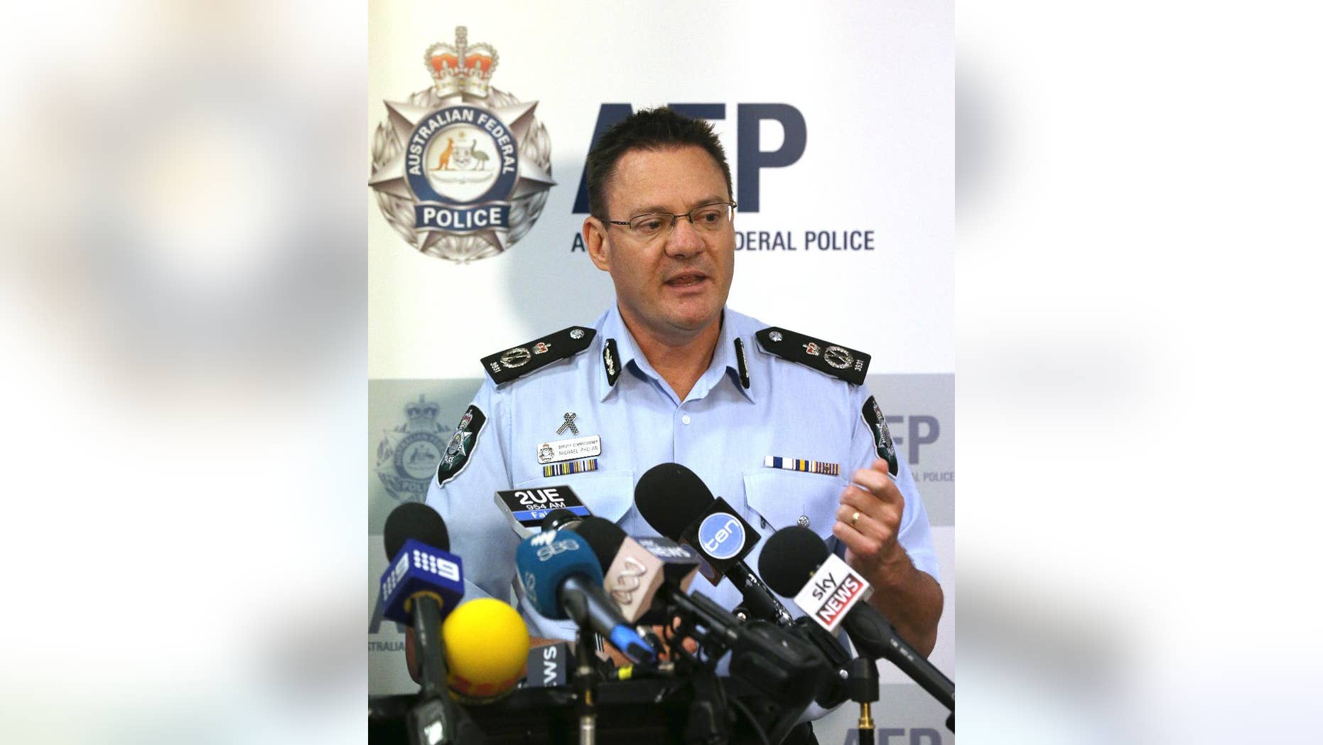 Australian Federal Police Deputy Commissioner Michael Phelan speaks to the media that two Sydney men have been arrested by the Joint Counter Terrorism team in Sydney, Australia, Wednesday, Dec. 24, 2014. Phelan said there was no specific terrorist threat and the arrests were related to an ongoing counterterrorism operation that led to a series of raids in Sydney in September. (AP Photo/Rob Griffith)