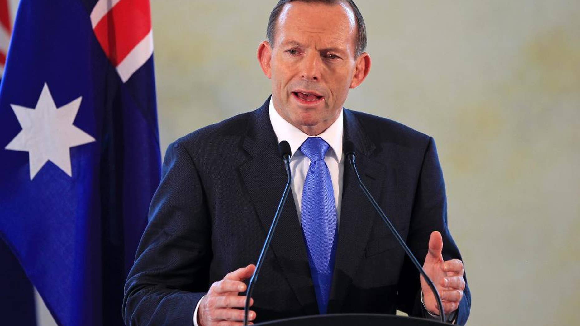 FILE - In this Sept. 6, 2014 file photo, Australian Prime Minister Tony Abbott speaks during a joint press conference with his Malaysian counterpart Najib Razak after a meeting in Putrajaya, Malaysia. The Australian government on Friday, Sept. 12, 2014 elevated its terrorism threat level to the second-highest warning in response to the domestic threat posed by Islamic State movement supporters. (AP Photo/Lai Seng Sin, File)