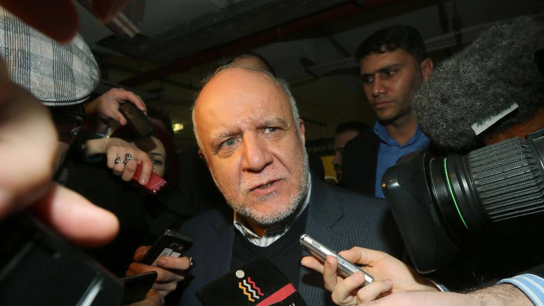 Iran's Minister of Petroleum Bijan Namdar Zangeneh talks to journalists as he arrives at a hotel for a meeting of the Organization of the Petroleum Exporting Countries, OPEC, in Vienna, Austria, Wednesday, Nov. 26, 2014. (AP Photo/Ronald Zak)