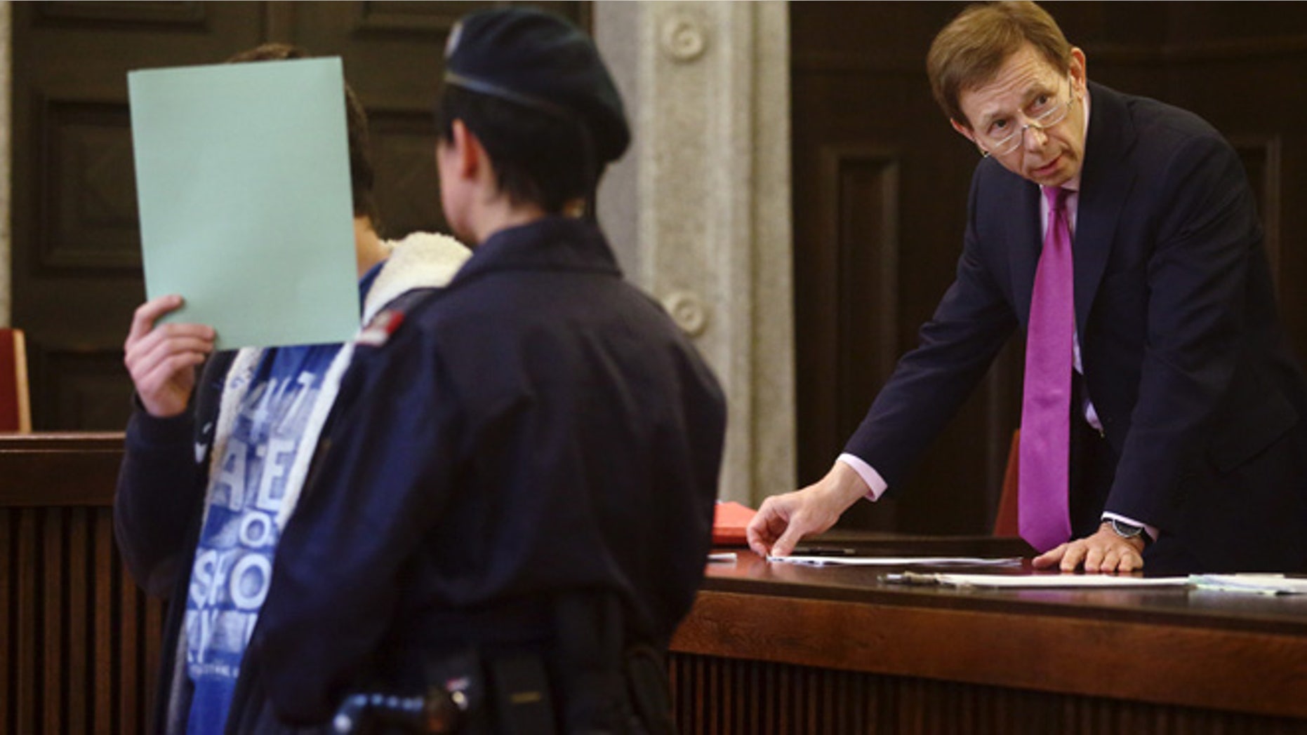 May 26, 2015: A 14-year-old terror suspect, accused of preparing to join militant fighters in Syria and researching how to build a bomb, and his lawyer Rudolf Mayr (R) wait for the start of his trial in St. Poelten, Austria.
