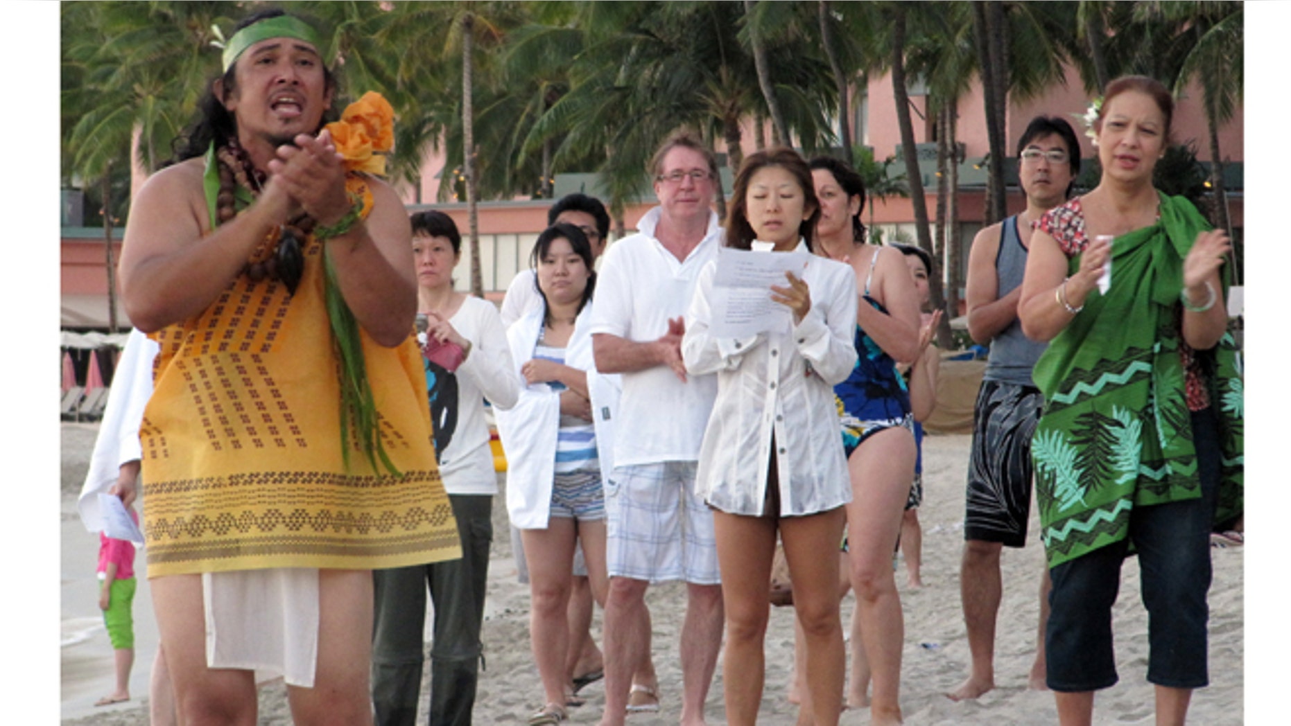 Aug. 17, 2012: Kalama Cabigon, a kahu, or caretaker, leads a chant on Waikiki beach outside the Moana Surfrider hotel in Honolulu.