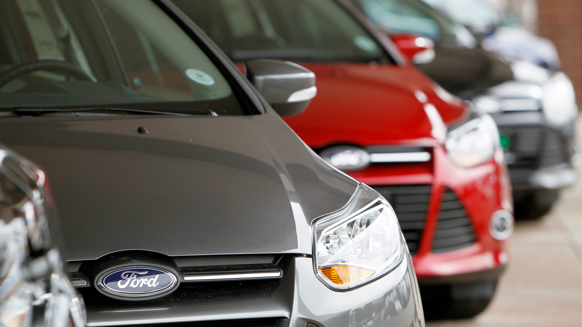This Feb. 19, 2012 photo, shows a line of 2012 Focus sedans at a Ford dealership in the south Denver suburb of Littleton, Colo. Ford Motor Co. said Thursday, March 1, 2012, its U.S. sales rose 14 percent in February thanks to big demand for its Focus compact car. (AP Photo/David Zalubowski)