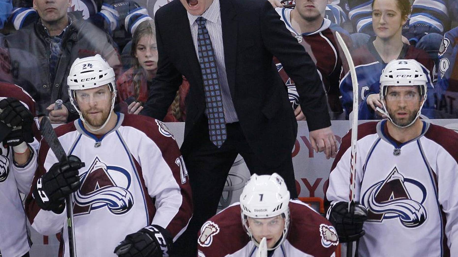 FILE - In this Dec. 12, 2013 file photo, Colorado Avalanche's head coach Patrick Roy yells on the bench as Marc-Andre Cliche (24), John Mitchell (7) and Maxime Talbot (25) look on during third period action against the Winnipeg Jets in in Winnipeg. Roy's pushed all the right buttons in leading a team that finished last in the Western Conference a season ago back into the playoffs. (AP Photo/The Canadian Press, John Woods)