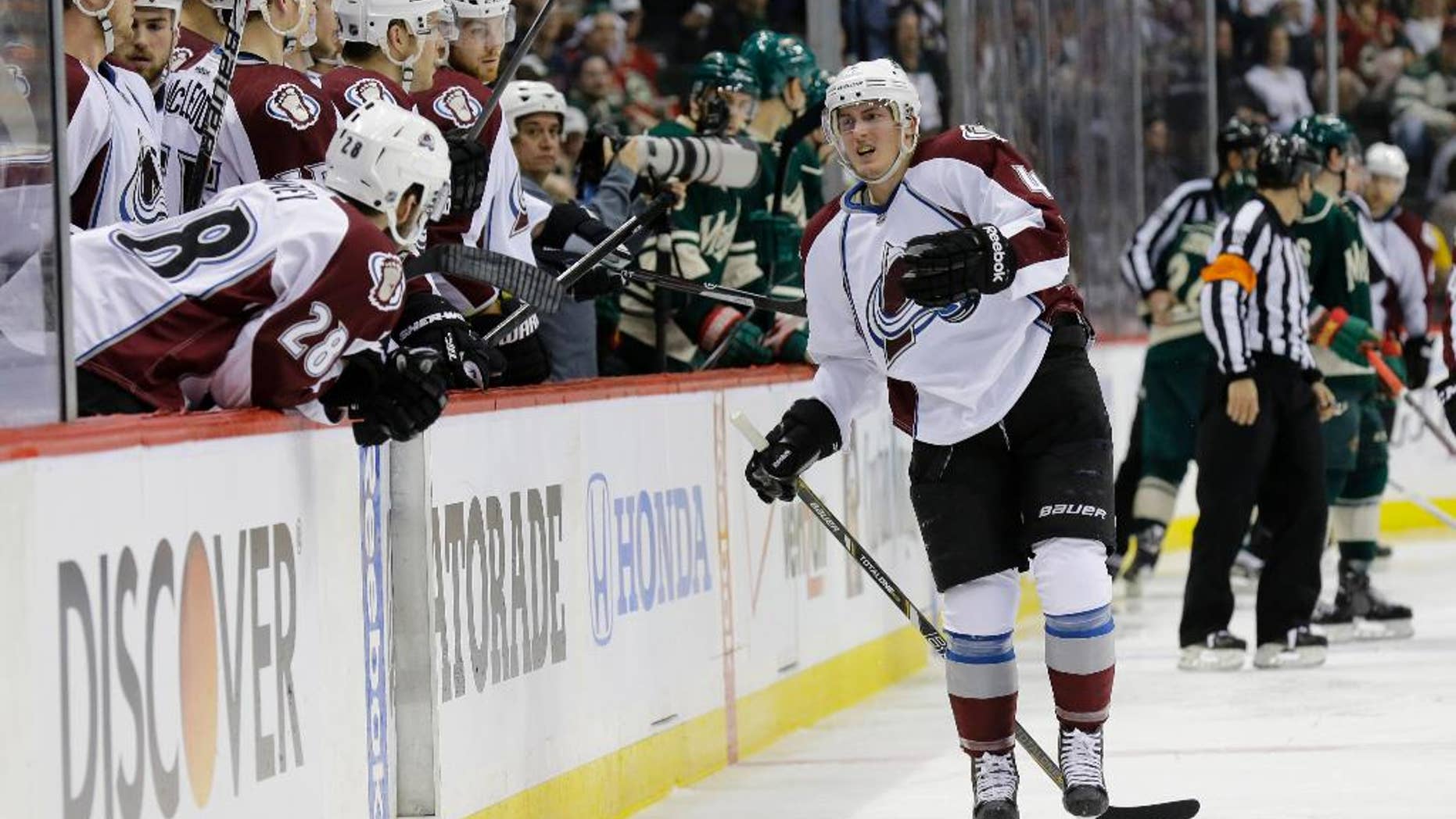 Colorado Avalanche defenseman Tyson Barrie, right, leaves the ice after getting injured on a hit by Minnesota Wild left wing Matt Cooke during the second period of Game 3 of an NHL hockey first-round playoff series in St. Paul, Minn., Monday, April 21, 2014. The Wild won 1-0 in overtime. (AP Photo/Ann Heisenfelt)