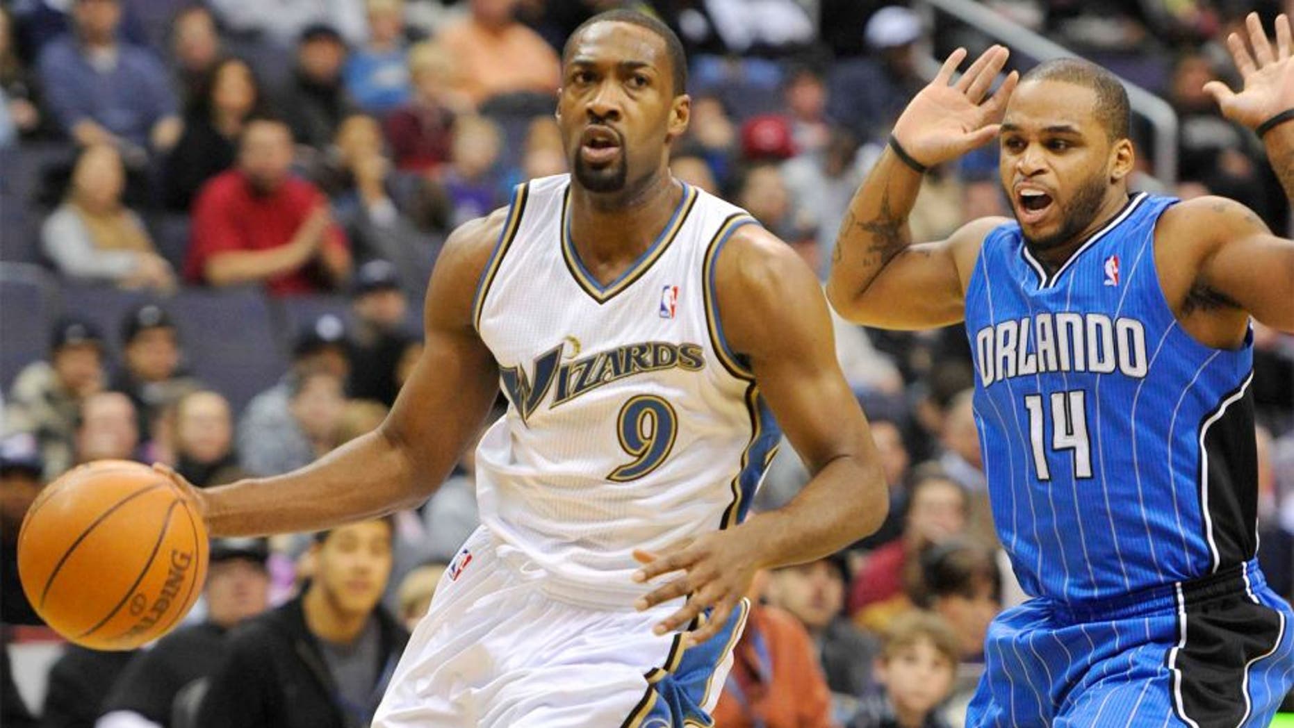 Nov 27, 2010; Washington, DC, USA; Washington Wizards point guard Gilbert Arenas (9) dribbles by and is fouled by Orlando Magic point guard Jameer Nelson (14) during the first half at the Verizon Center. Mandatory Credit: Rafael Suanes-USA TODAY Sports