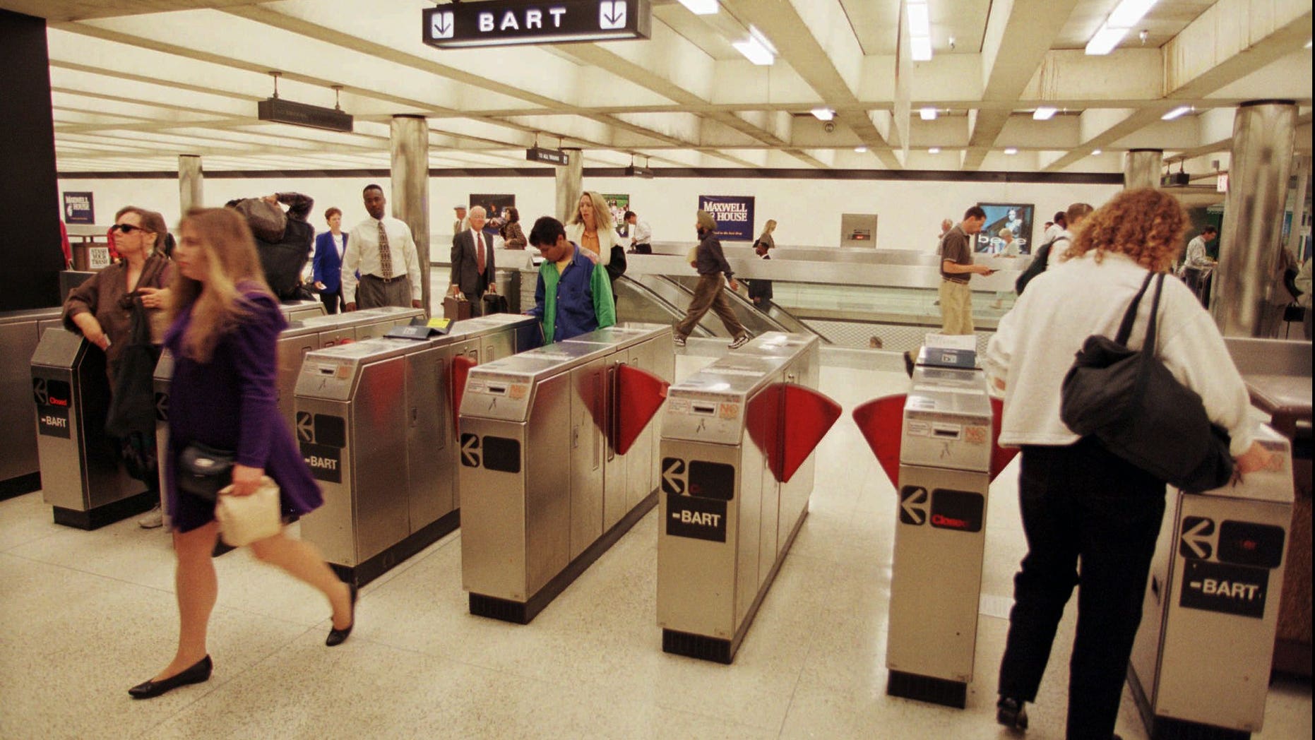 Commuters enter and exit a Bay Area Rapid Transit station in San Francisco's financial district.