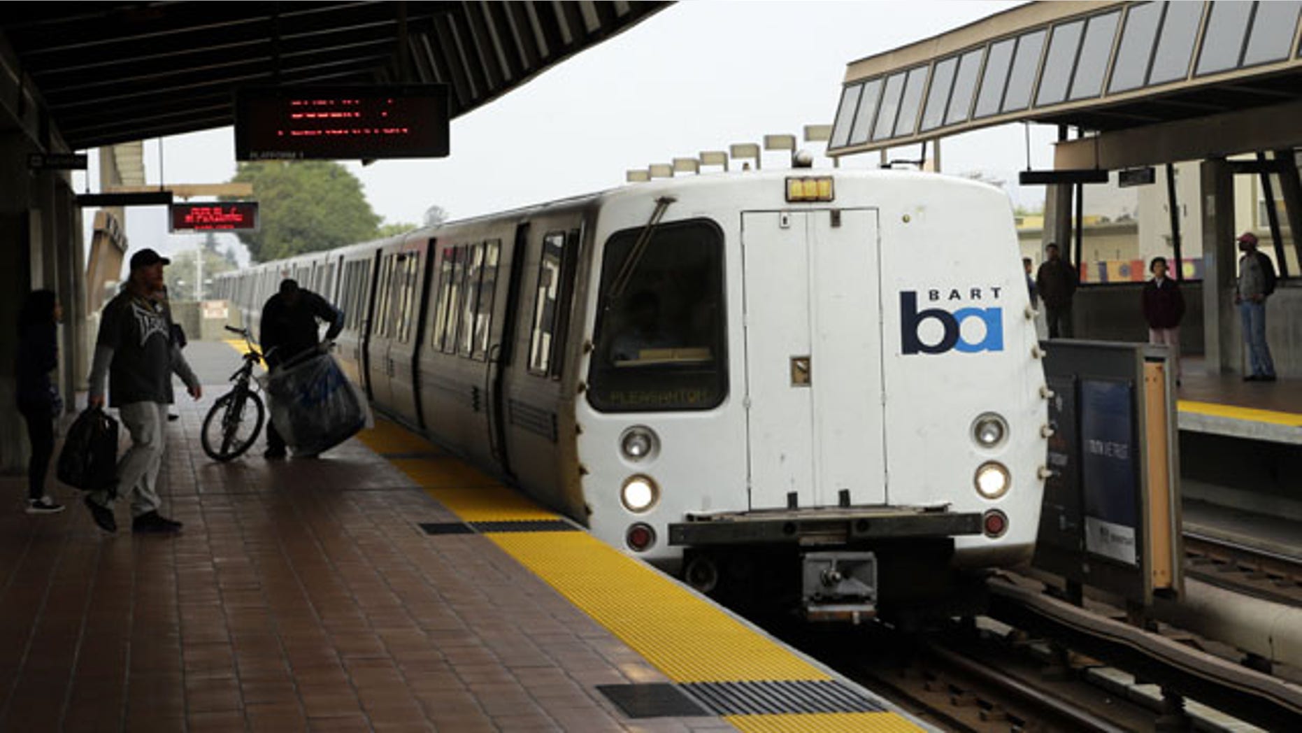 October 12, 2013: Bay Area Rapid Transit travelers wait to board an arriving train in Oakland, Calif. (AP Photo)