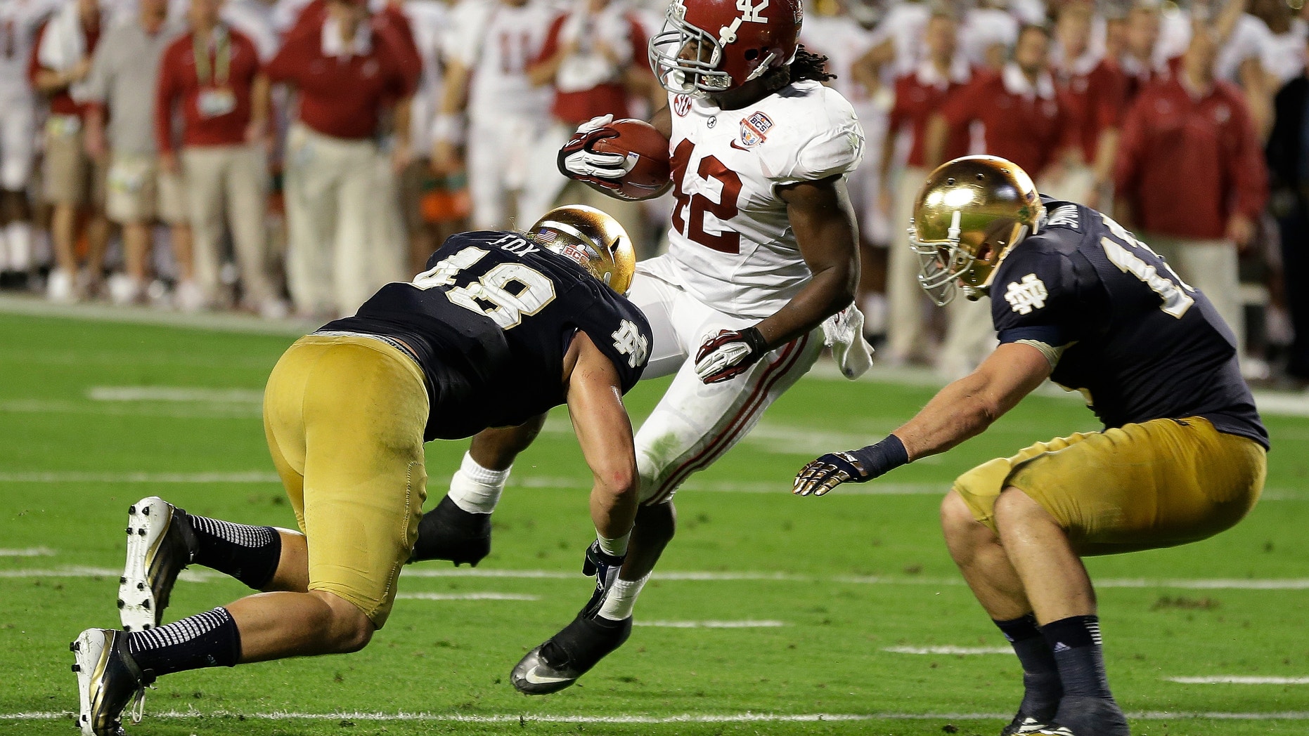 Jan. 7, 2013: Alabama's Eddie Lacy spins past Notre Dame's Dan Fox (48) and Danny Spond for a touchdown during the first half of the BCS National Championship college football game.