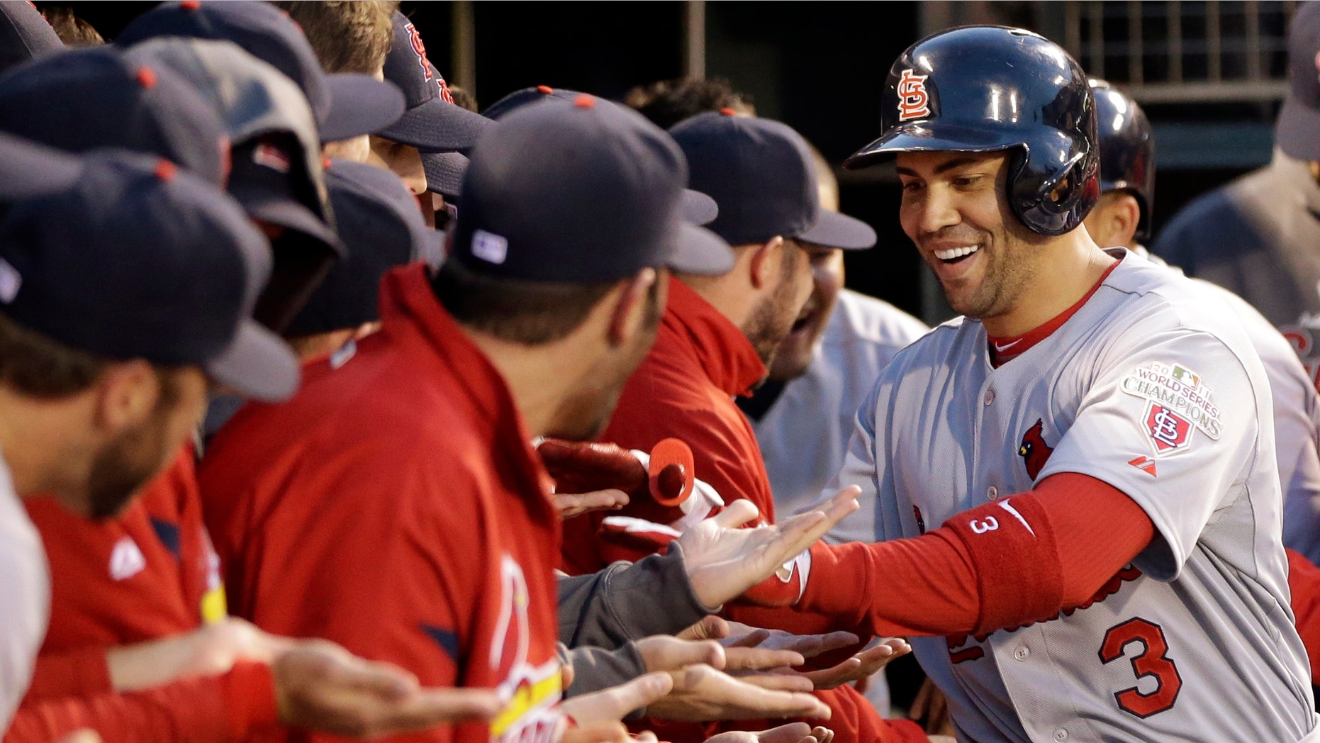 St. Louis Cardinals' Carlos Beltran (3) is congratulated in the dugout after hitting a two-run home run during the fourth inning in Game 1 of baseball's National League championship series against the San Francisco Giants Sunday, Oct. 14, 2012, in San Francisco. (AP Photo/David J. Phillip)