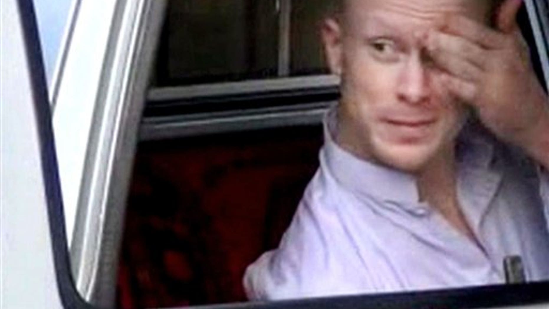 File - In this file image taken from video obtained from Voice Of Jihad Website, which has been authenticated based on its contents and other AP reporting, Sgt. Bowe Bergdahl, sits in a vehicle guarded by the Taliban in eastern Afghanistan. (AP Photo/Voice Of Jihad Website via AP video, File)