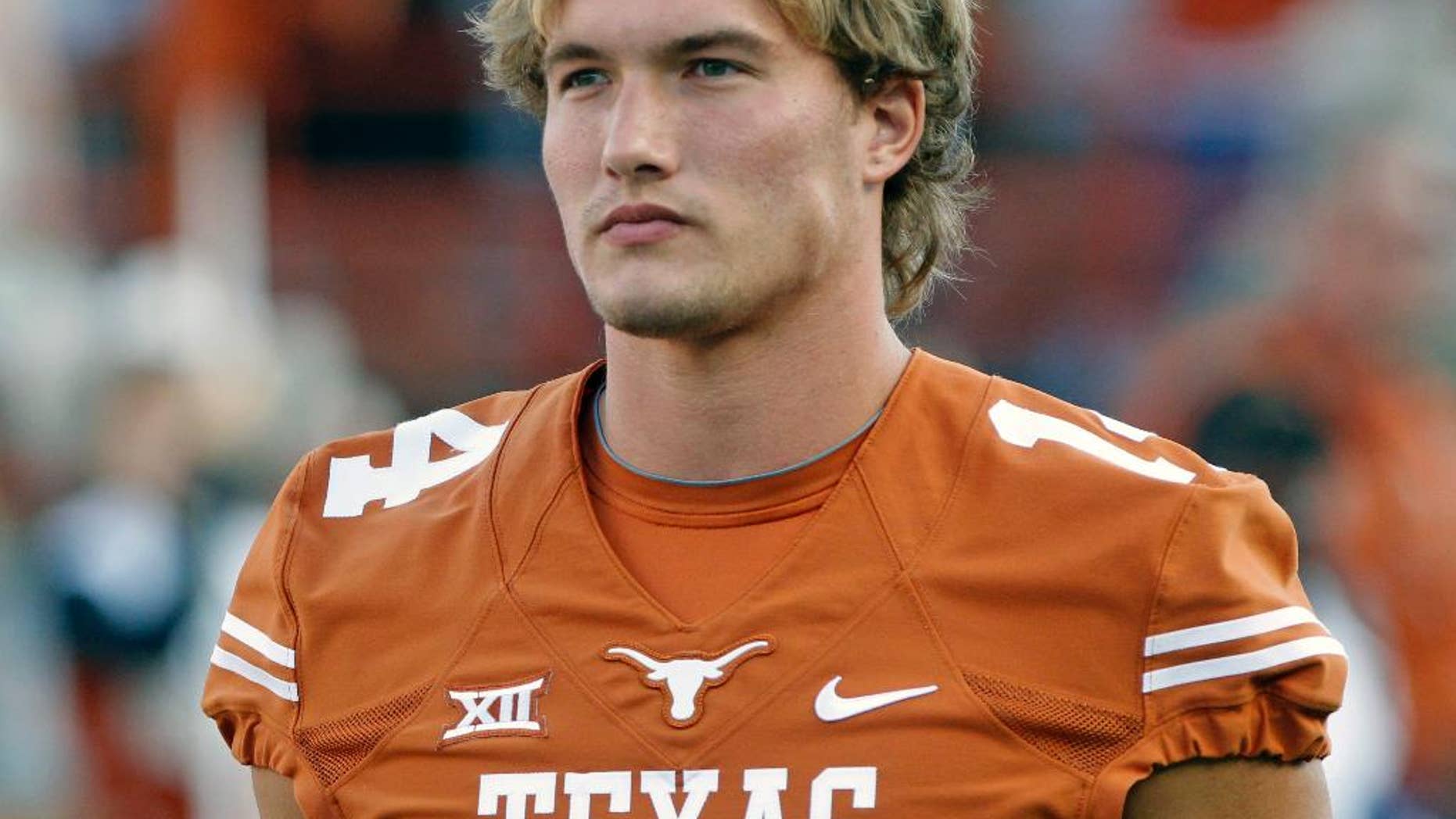 Texas quarterback David Ash comes onto the field before an NCAA college football game against BYU in Austin, Texas, Saturday, Sept. 6, 2014. (AP Photo/Michael Thomas)