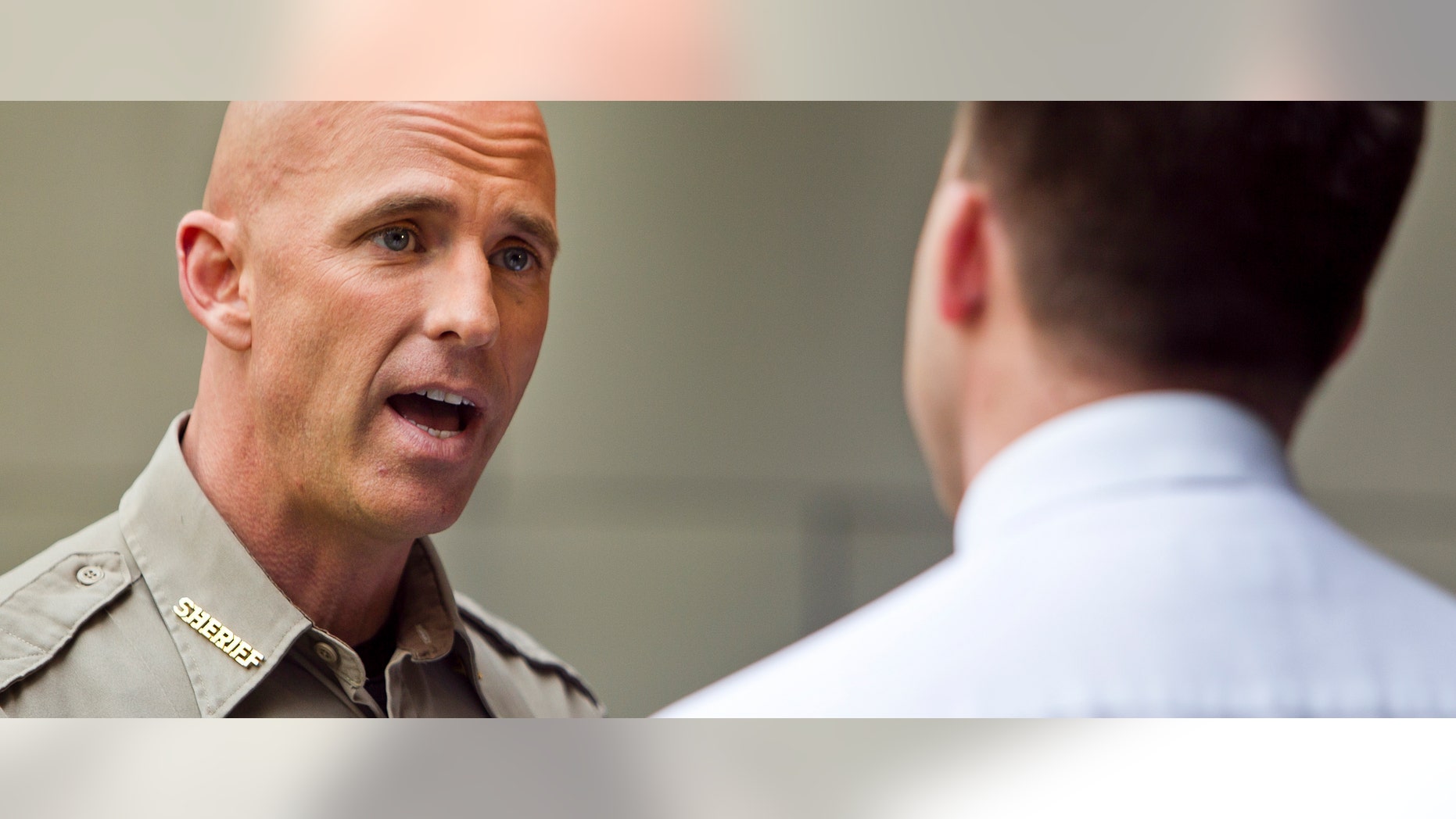 Pinal County Sheriff Sheriff Paul Babeu, left, is interviewed by KPNX reporter William Pitts at the Mesa Arts Center, Monday, Feb. 12, 2012 in Mesa, Ariz. (AP Photo/The Arizona Republic, Tom Tingle)