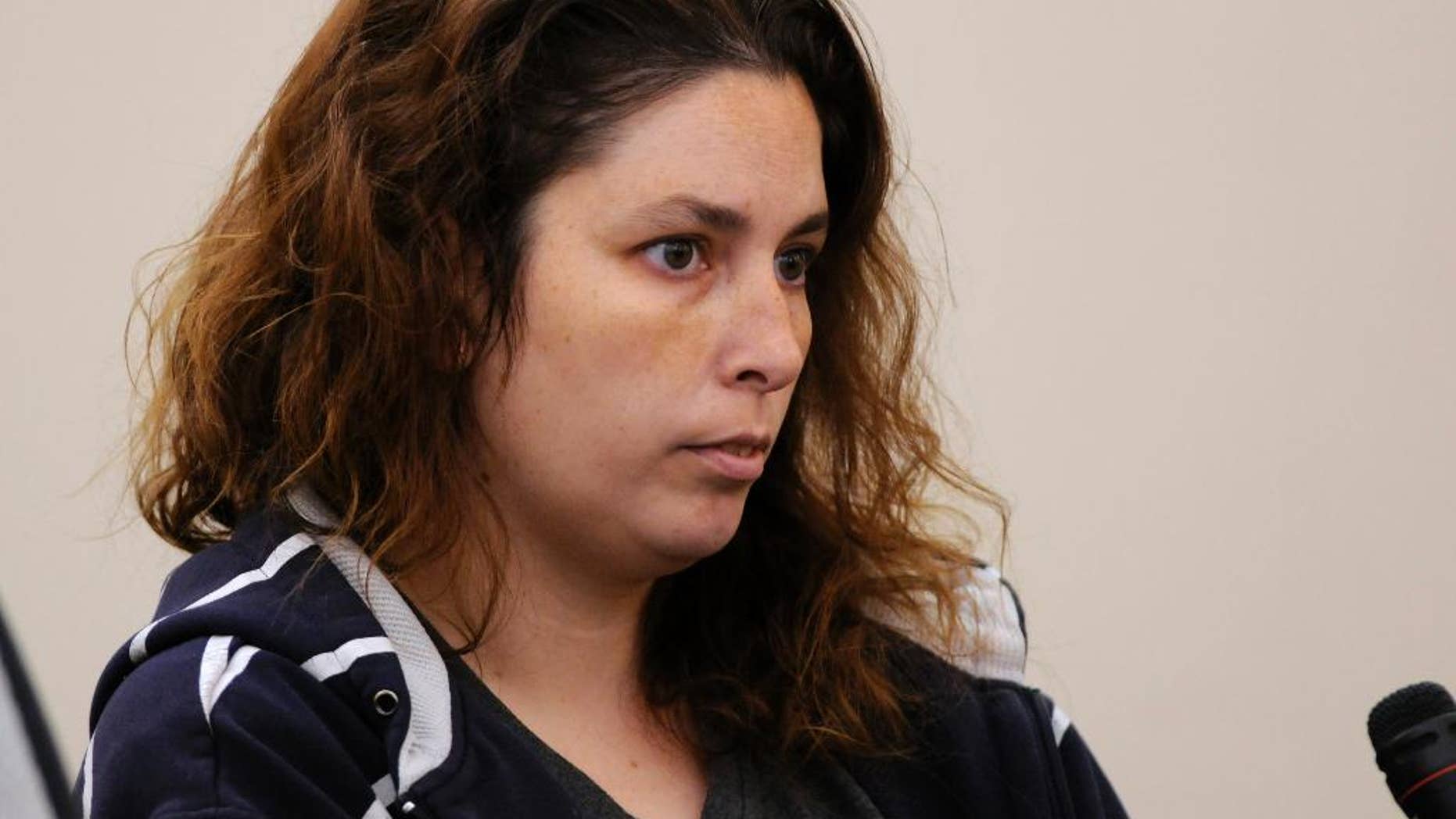 Erika Murray is arraigned at Uxbridge District Court in Uxbridge, Mass. on Friday, Sept. 12, 2014. Murray, 31, was arrested Thursday night on charges including fetal death concealment, witness intimidation and permitting substantial injury to a child. Not guilty pleas were entered Friday on her behalf. Detectives investigating a case of reckless endangerment of children found the bodies this week at the house littered with soiled diapers in Blackstone, about 50 miles southwest of Boston. (AP Photo/Worcester Telegram & Gazette, Paul Kapteyn, Pool)