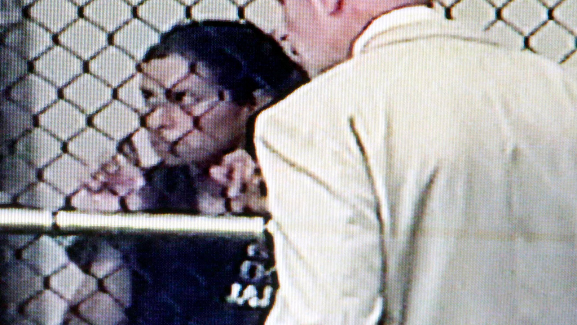 August 24: Sonia Hermosillo, 31, confers with her defense attorney at a video arraignment at the Santa Ana, California jail. Prosecutors say Hermosillo took off a special helmet that her son wore for a medical condition and tossed him over the edge of the parking structure at Children's Hospital of Orange County before validating her parking and driving away earlier this week. The boy died on Wednesday.