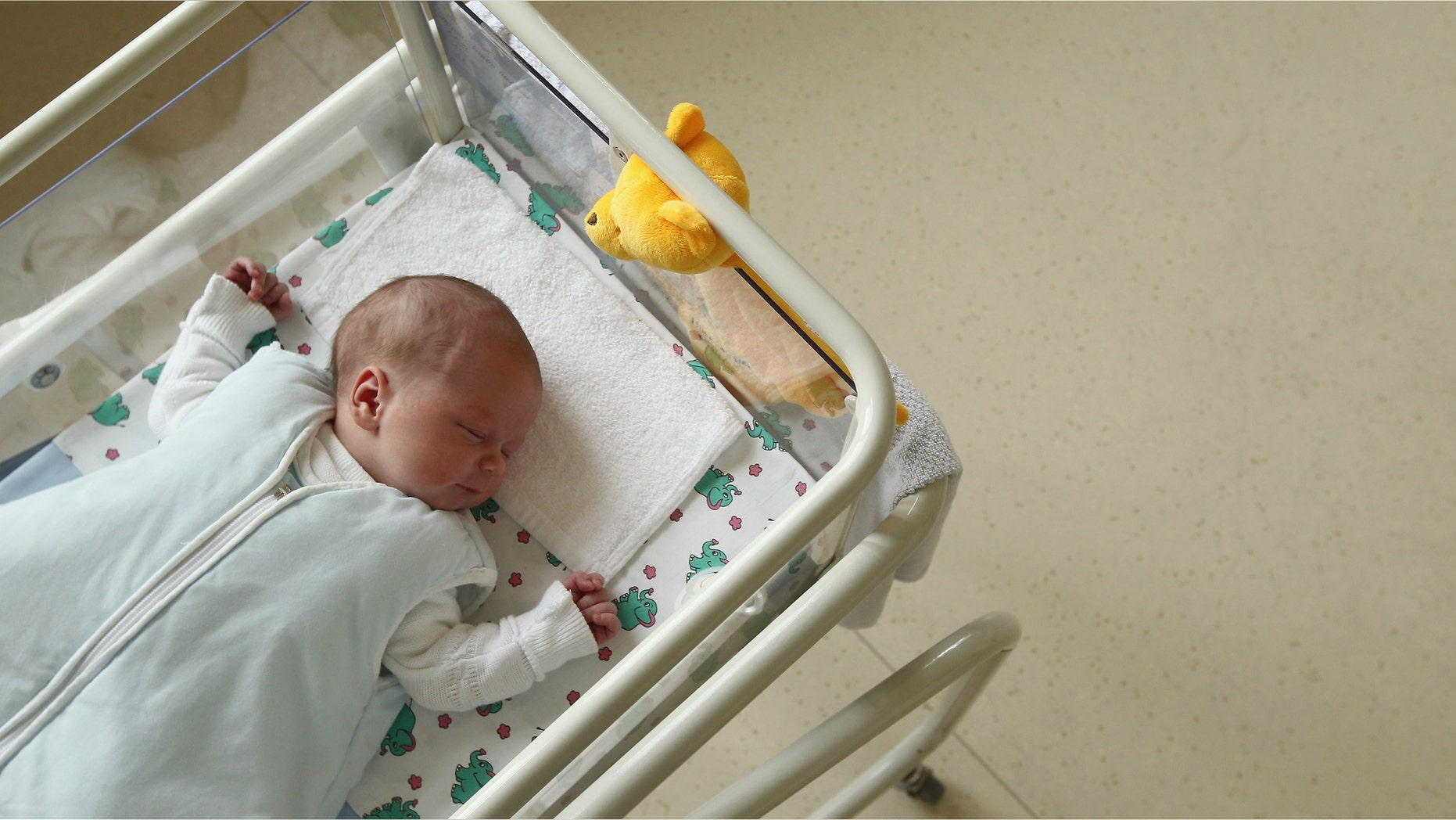 UNDISCLOSED, GERMANY - AUGUST 12: A 4-day-old newborn baby lies in a baby bed in the maternity ward of a hospital (a spokesperson for the hospital asked that the hospital not be named) on August 12, 2011 in a city in the east German state of Brandenburg, Germany. According to data released by Eurostat last week Germany, with 8.3 births per 1,000 people, has the lowest birth rate in all of Europe. Eastern Germany, which not only suffers from a low birth rate, also has a declining population due to young people moving away because of high unemployment in the region. Europe as a whole suffers from a low birth rate and a growing elderly population. (Photo by Sean Gallup/Getty Images)