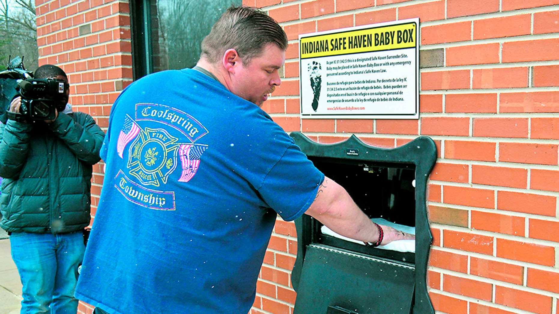 In this Monday, April 9, 2018, photo, Lt. Chuck Kohler, with the Coolspring Township Volunteer Fire Department, shows how a mother can relinquish her newborn, anonymously and without fear of prosecution, using the Safe Haven Baby Box, in Michigan City, Ind.