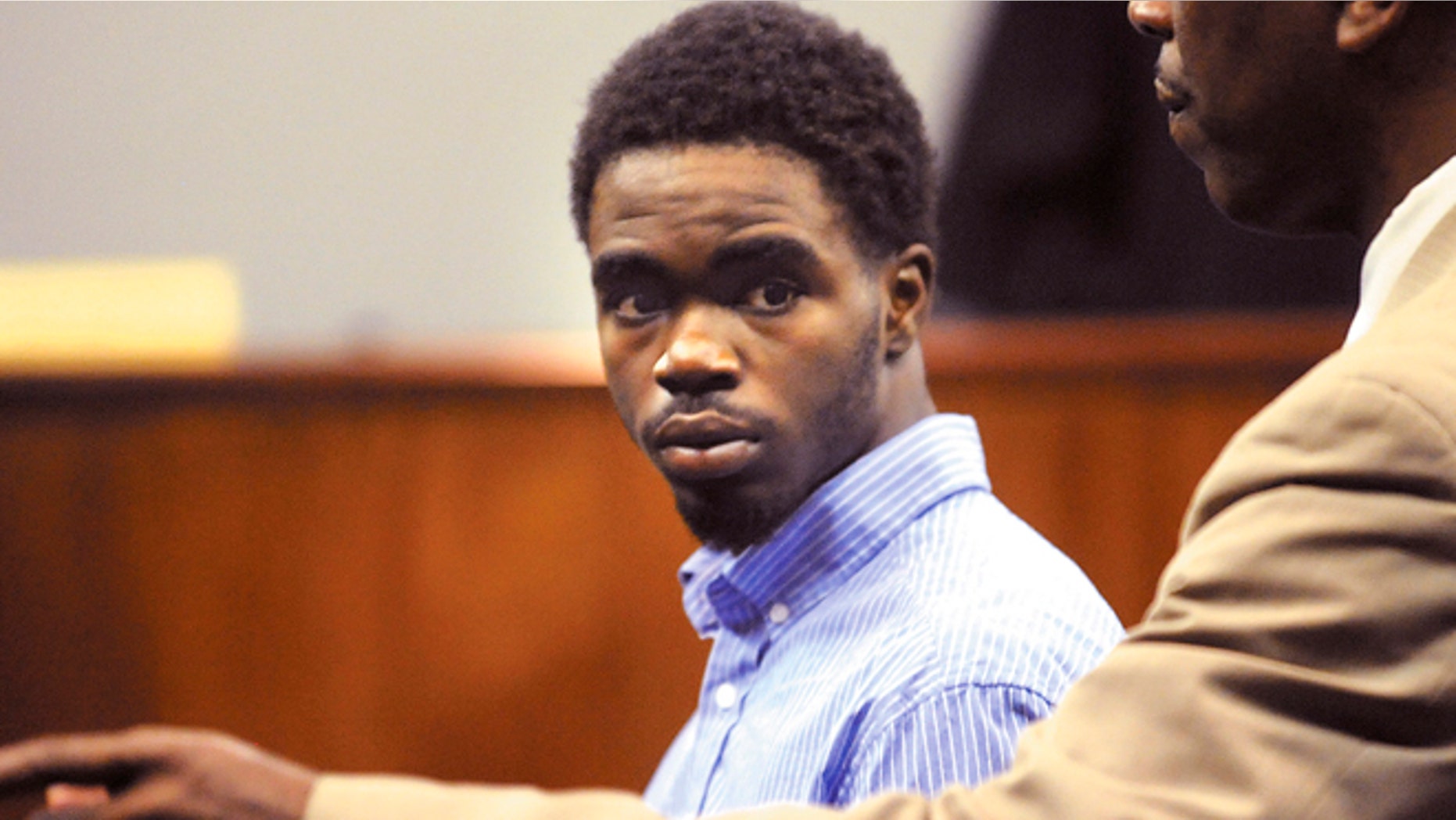 March 25: A Glynn County Sheriff's Deputy directs 17 year-old De Marquise Elkins out of the courtroom in the Glynn County Courthouse in Brunswick, Ga.