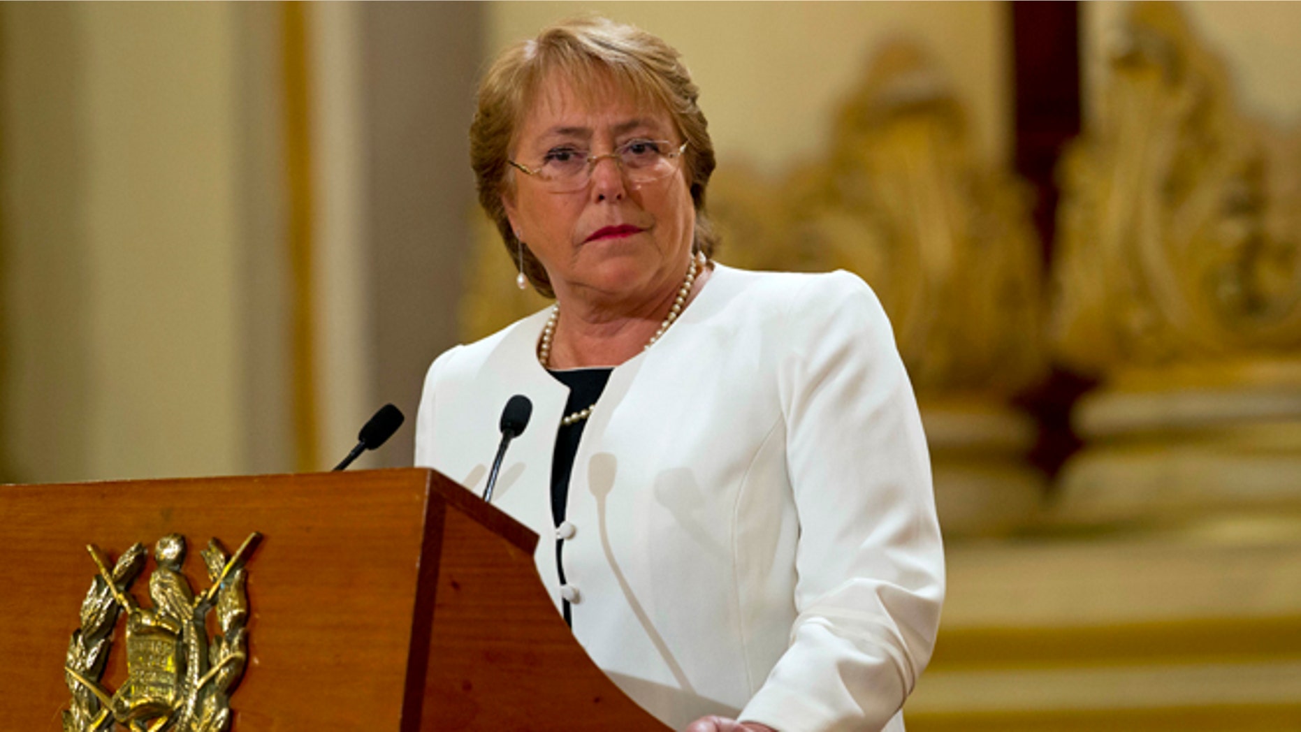 FILE - In this Friday, Jan. 30, 2015, file photo, Chile's President Michelle Bachelet listens to Guatemala's President Otto Perez Molina during their joint press conference at the National Palace in Guatemala City. President Bachelet has asked on Wednesday, May 6, 2015, for all her Cabinet ministers to submit their resignations. (AP Photo/Moises Castillo, File)
