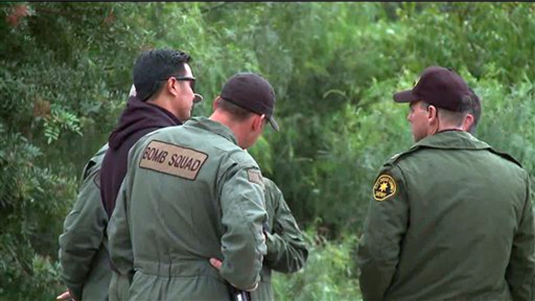 Nov. 24, 2010: Image provided by KSWB-TV shows San Diego County Sheriff Bomb Squad officers at the site of a discovery of explosive material inside a home in Escondido, Calif. The officers also seized evidence that suggested use for armed robberies.
