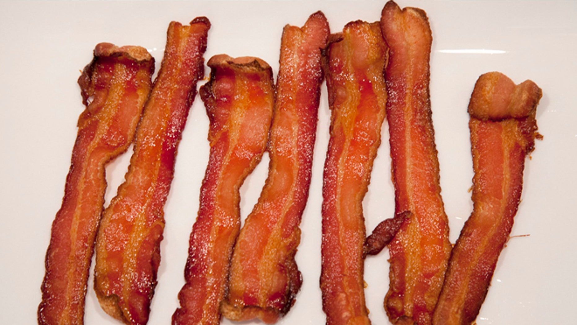 This Wednesday, Sept. 26, 2012 photo shows strips of cooked Bacon at a home in North Vancouver, British Columbia, Canada. A British farming organization is predicting a worldwide shortage of bacon and pork in 2013. The National Pig Association says global drought conditions are driving up the price of grain, a major staple in hog feed. It says pig farmers around the world are selling their herds because retail prices are not rising fast enough to cover the cost of record-high pig-feed costs. (The Canadian Press, Jonathan Hayward)