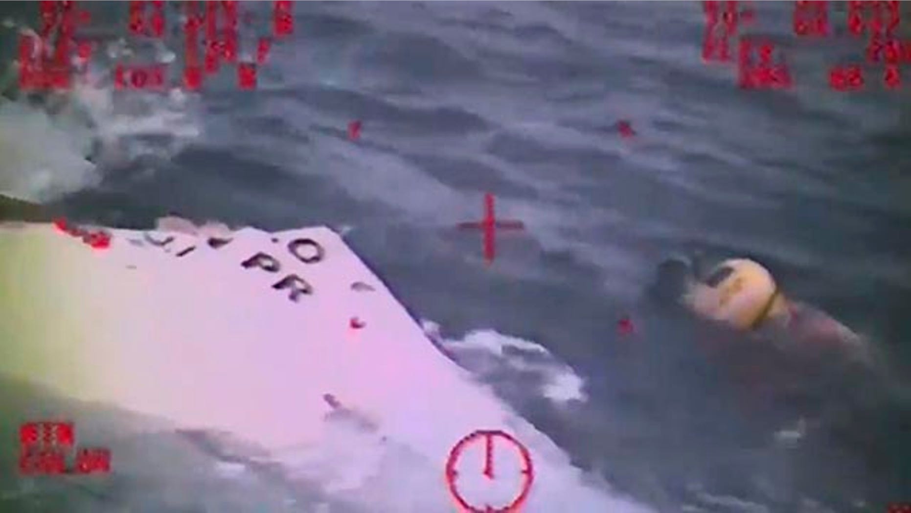 Oct. 4, 2015: In this photo made from video and released by the U.S. Coast Guard, a Coast Guard crew member investigates a life boat that was found from the missing ship El Faro. (U.S. Coast Guard via AP)