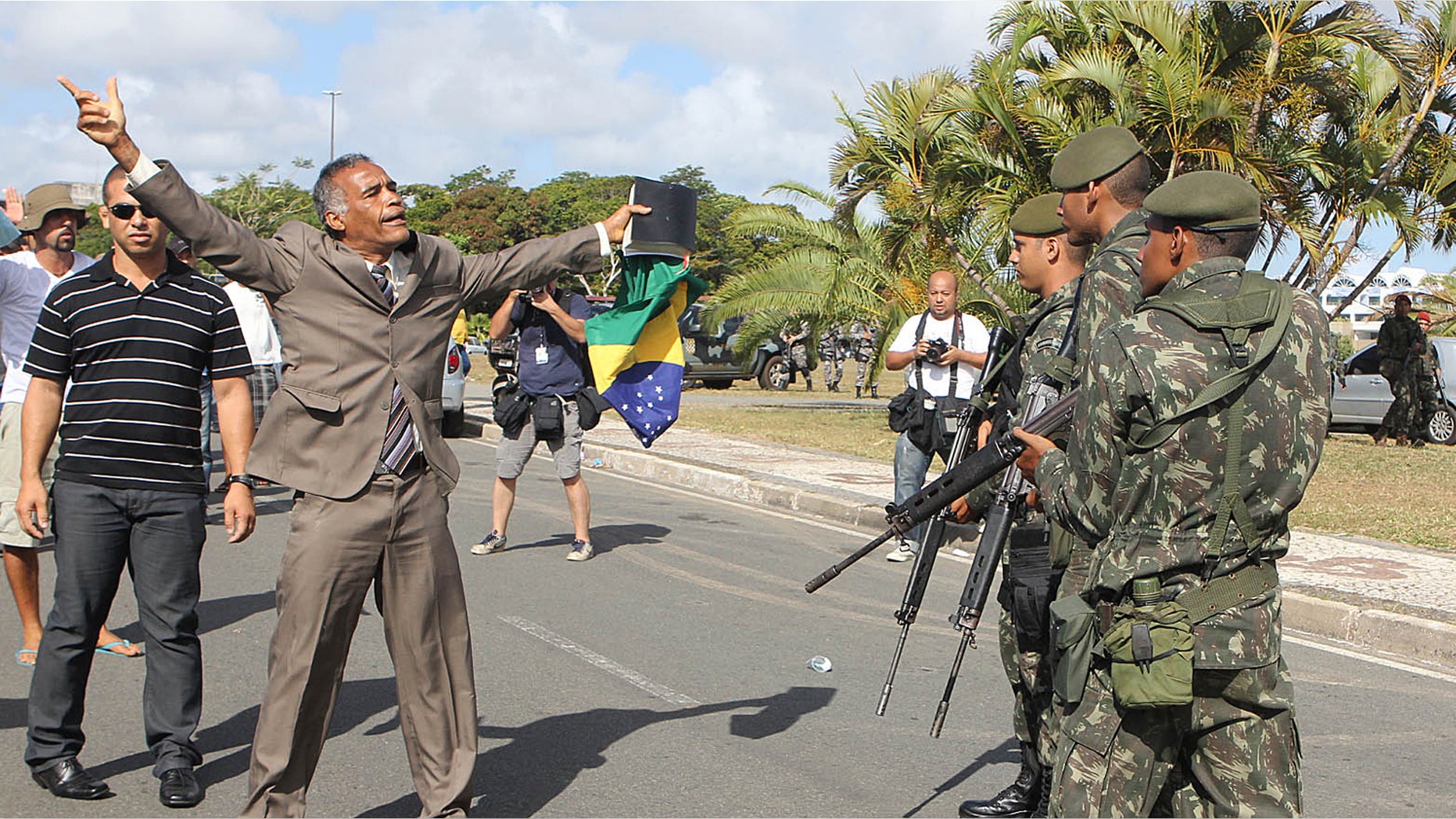 A protester shouts to soldiers during a police strike, in Salvador, Brazil, Monday, Feb. 6, 2012. Murder rates in Brazil's northeastern city of Salvador have more than doubled since the start of a police strike, media reports said Sunday. The strike has thrown a pall over preparations for Carnival in Brazil's third largest city, unleashing a rash of looting and a spike in the murder. (AP Photo/Paulo Macedo)