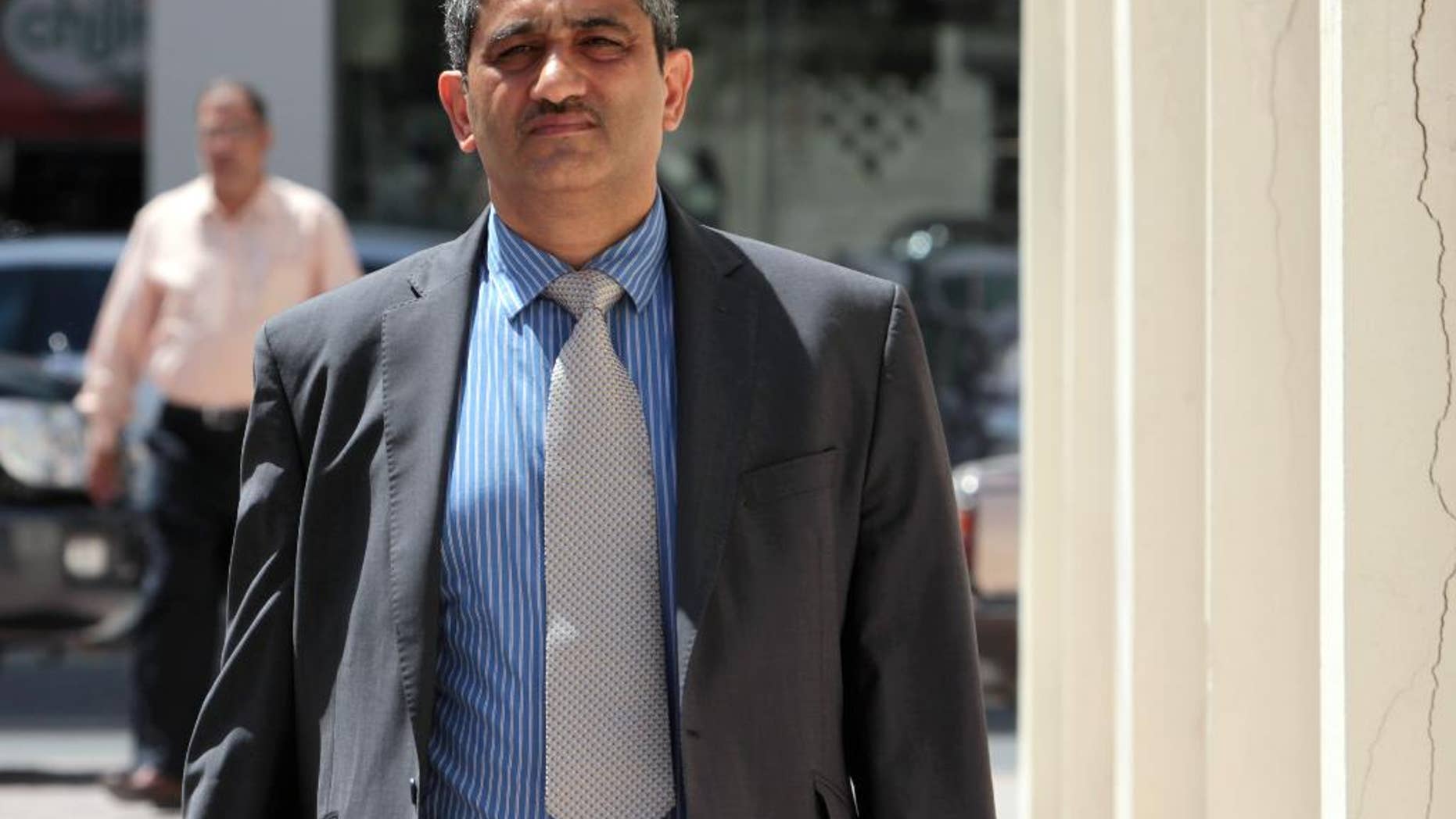 FILE - In this May 18, 2011, file photo, Mansour al-Jamri, former chief editor of the Bahraini opposition newspaper Al Wasat, arrives at the courthouse in Manama, Bahrain. The official Bahrain News Agency said in a brief statement issued Thursday, Aug. 6, 2015, that the suspension of the publication of the independent newspaper Al-Wasat. is "due to its violation of the law and repeated dissemination of information that affects national unity and the Kingdom's relationship with other countries." (AP Photo/Hasan Jamali, File)