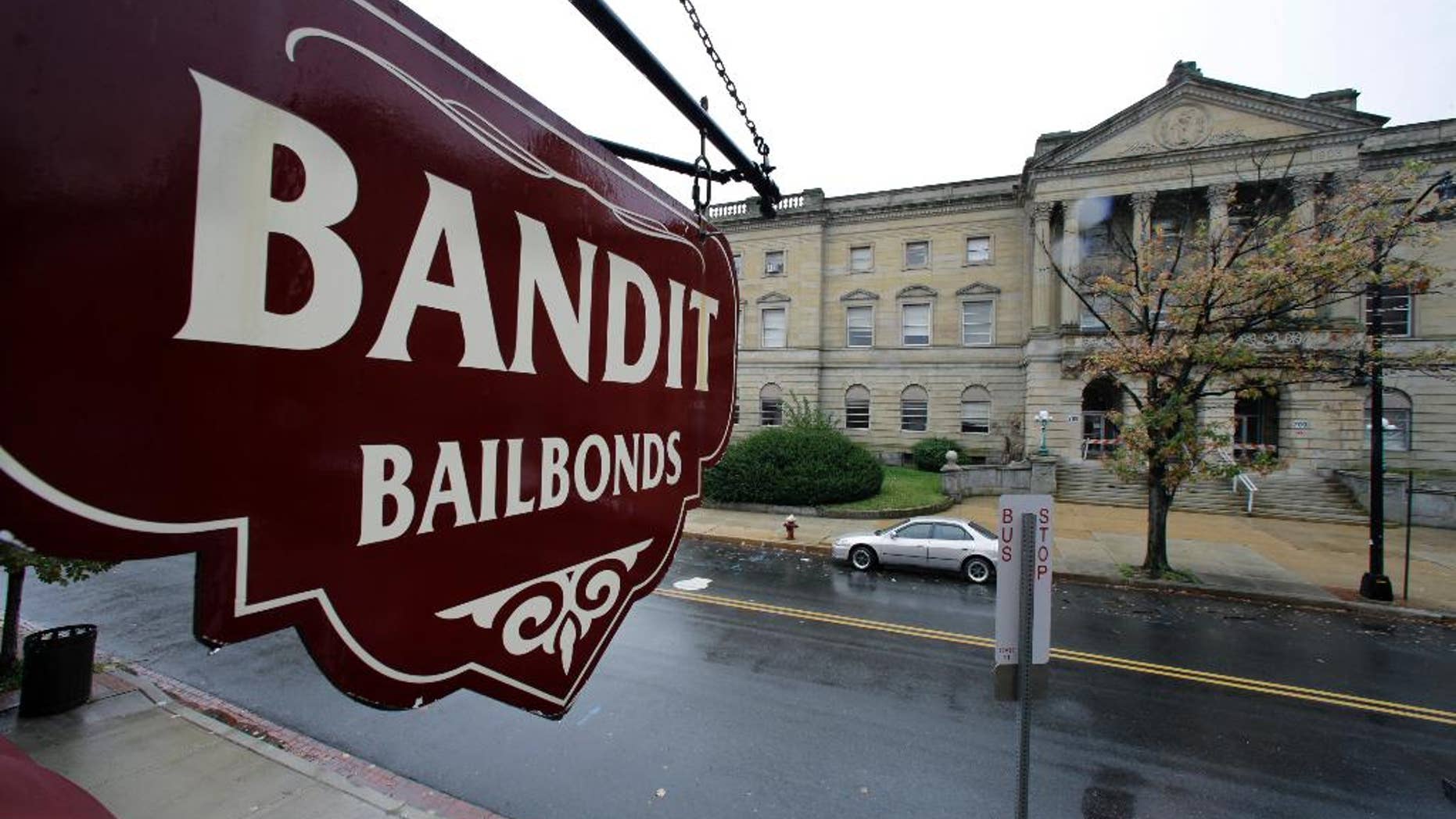 FILE-This Oct. 23, 2014 file photo a sign is seen outside a bail bondsman across the street from Mercer County criminal courthouse in Trenton, N.J. In courtrooms across the country every day, a price tag is put on freedom and for many it’s too expensive. With more than 60 percent of inmates in jails nationwide awaiting trial and many unable to afford bail, some states and counties are looking at overhauling the system so it’s based less on money and more on holding dangerous defendants. Earlier this year, New Jersey became the latest state to adopt a system that bases bail on a risk analysis of each defendant. (AP Photo/Mel Evans,File)