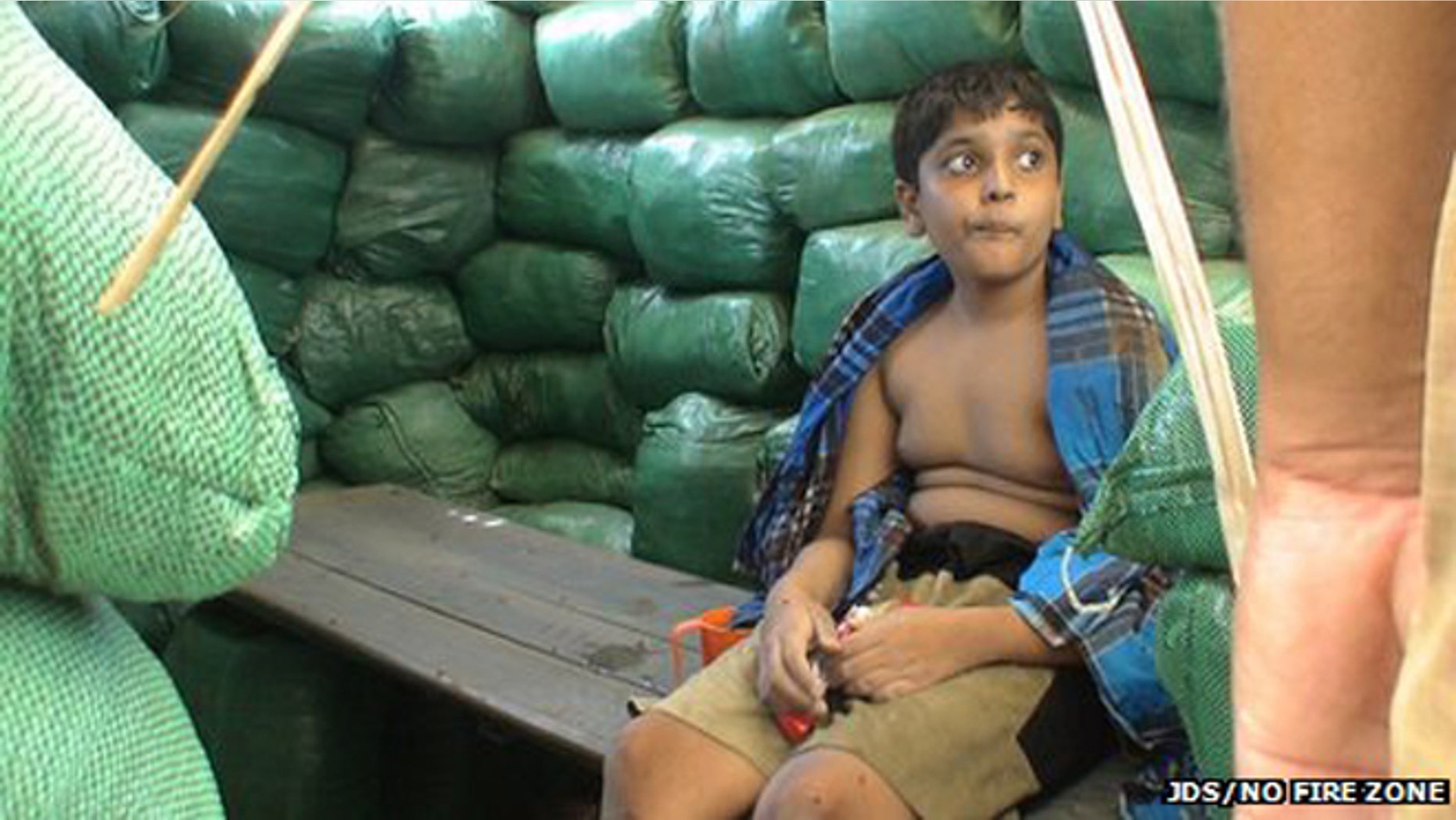 Balachandran Prabhakaran, shown eating chocolate while sitting on a bench.