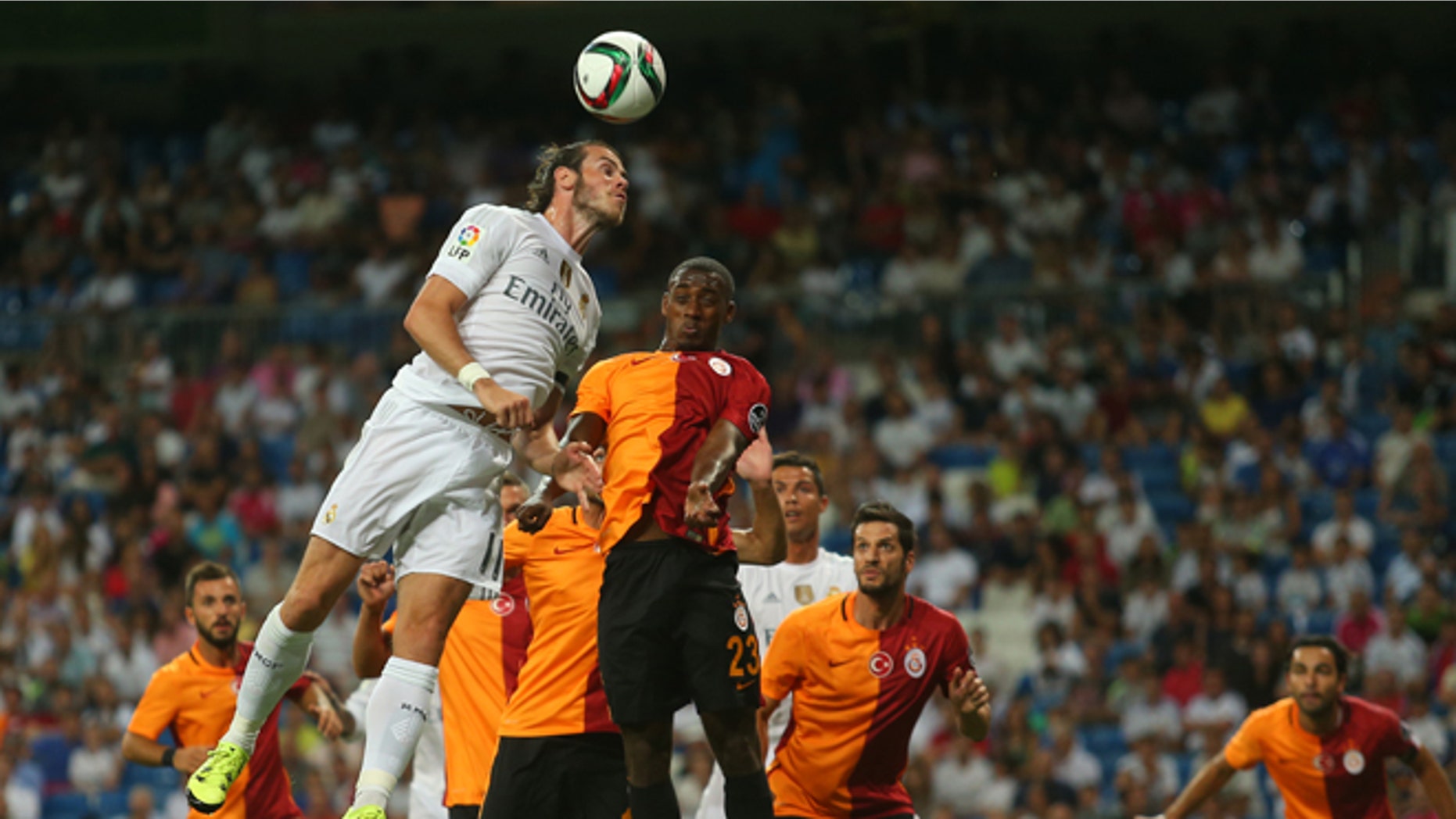 Real Madrid's Gareth Bale, top left, goes for a header with Galatasaray's Lionel Carole, top right, during the Santiago Bernabeu trophy soccer match between Real Madrid and Galatasaray at the Santiago Bernabeu stadium, in Madrid, Spain, Tuesday, Aug. 18, 2015. (AP Photo/Francisco Seco)
