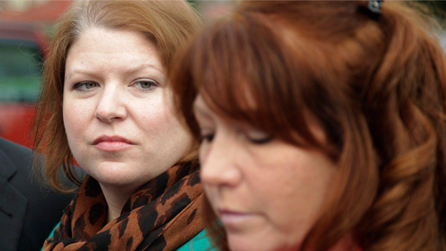 Nov. 13, 2012: Kari Bales, left, listens as her sister, Stephanie Tandberg, right, reads a statement to reporters outside the building housing a military courtroom on Joint Base Lewis McChord in Washington state.