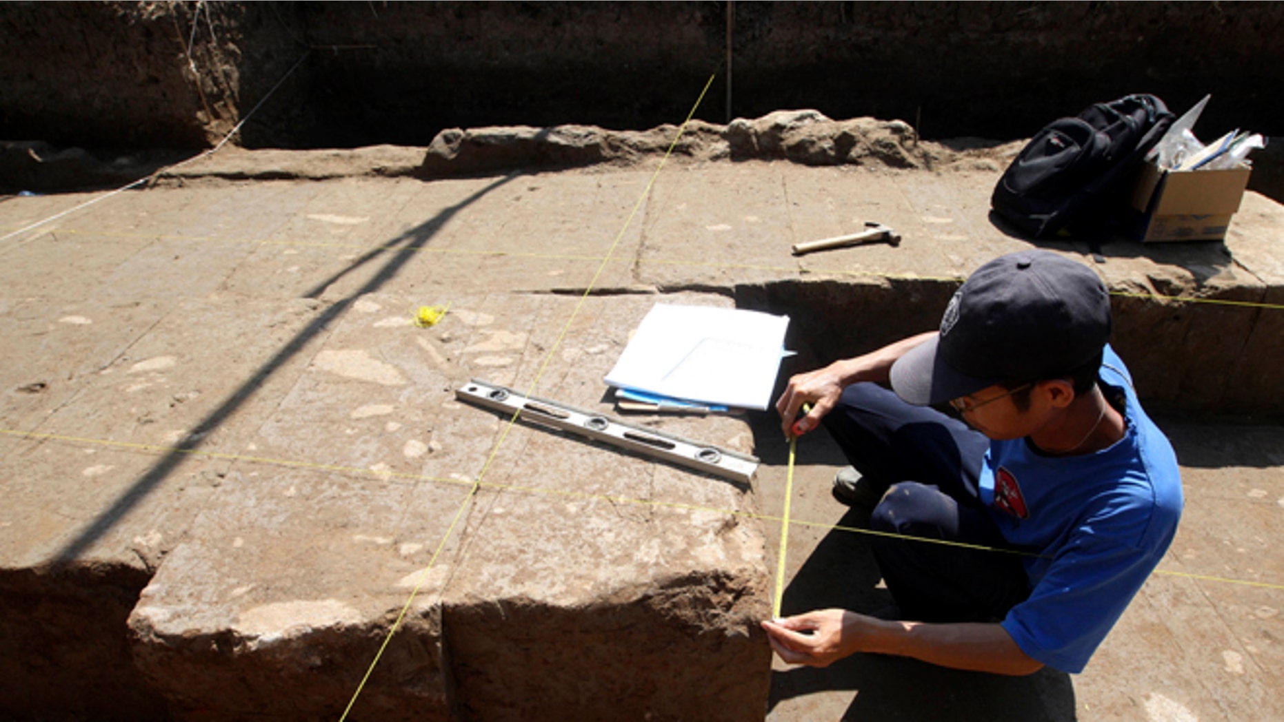 Oct. 26, 2012: A Balinese archaeologist measures a stone of ancient temple structure in Denpasar, Bali, Indonesia.