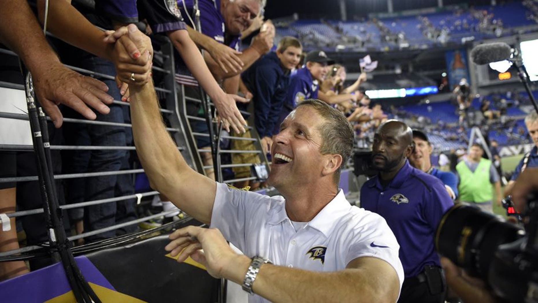 Baltimore Ravens coach John Harbaugh greets fans after an NFL football game against the Pittsburgh Steelers on Thursday, Sept. 11, 2014, in Baltimore. The Ravens won 26-6. (AP Photo/Nick Wass)