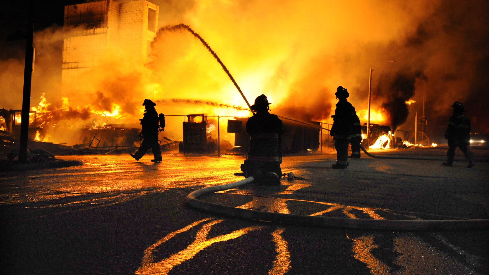 Baltimore firefighters battle a three-alarm fire Monday, April 27, 2015, at a senior living facility under construction at Federal and Chester Streets in East Baltimore.