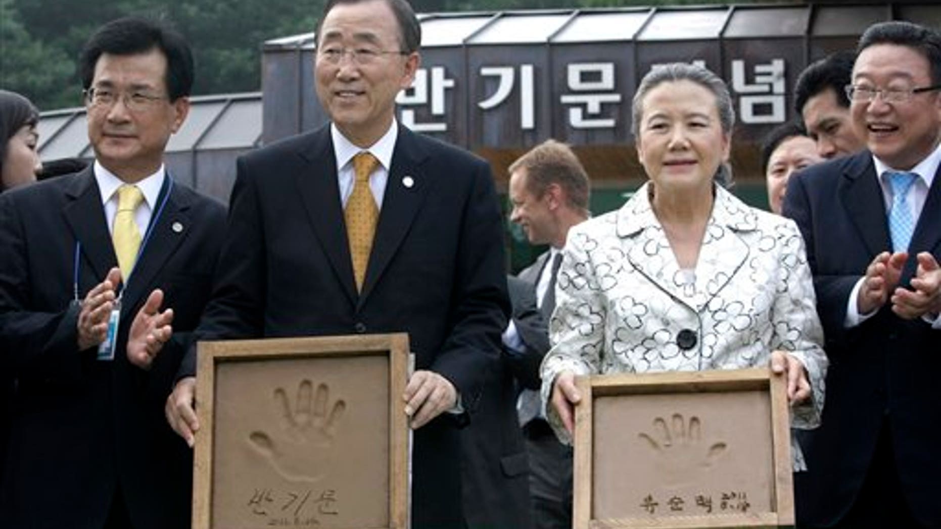 August 14: U.N. Secretary-General Ban Ki-moon and his wife, Yoo Soon-taek, show their hand prints during his visit to his hometown in Eumseong, South Korea.