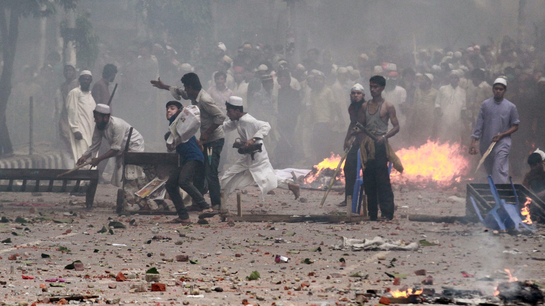 May 5, 2013 - Bangladeshi protesters throw stones at policemen during a protest in Dhaka, Bangladesh.